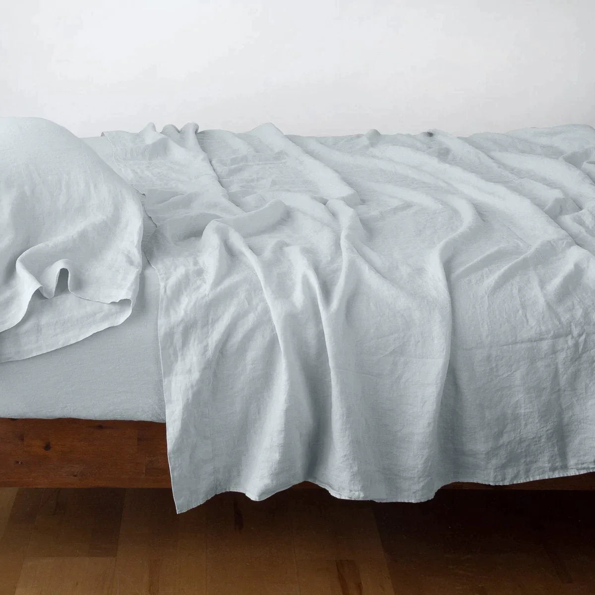 Cloud: Rumpled linen sheeting with matching sleeping pillow - side view.