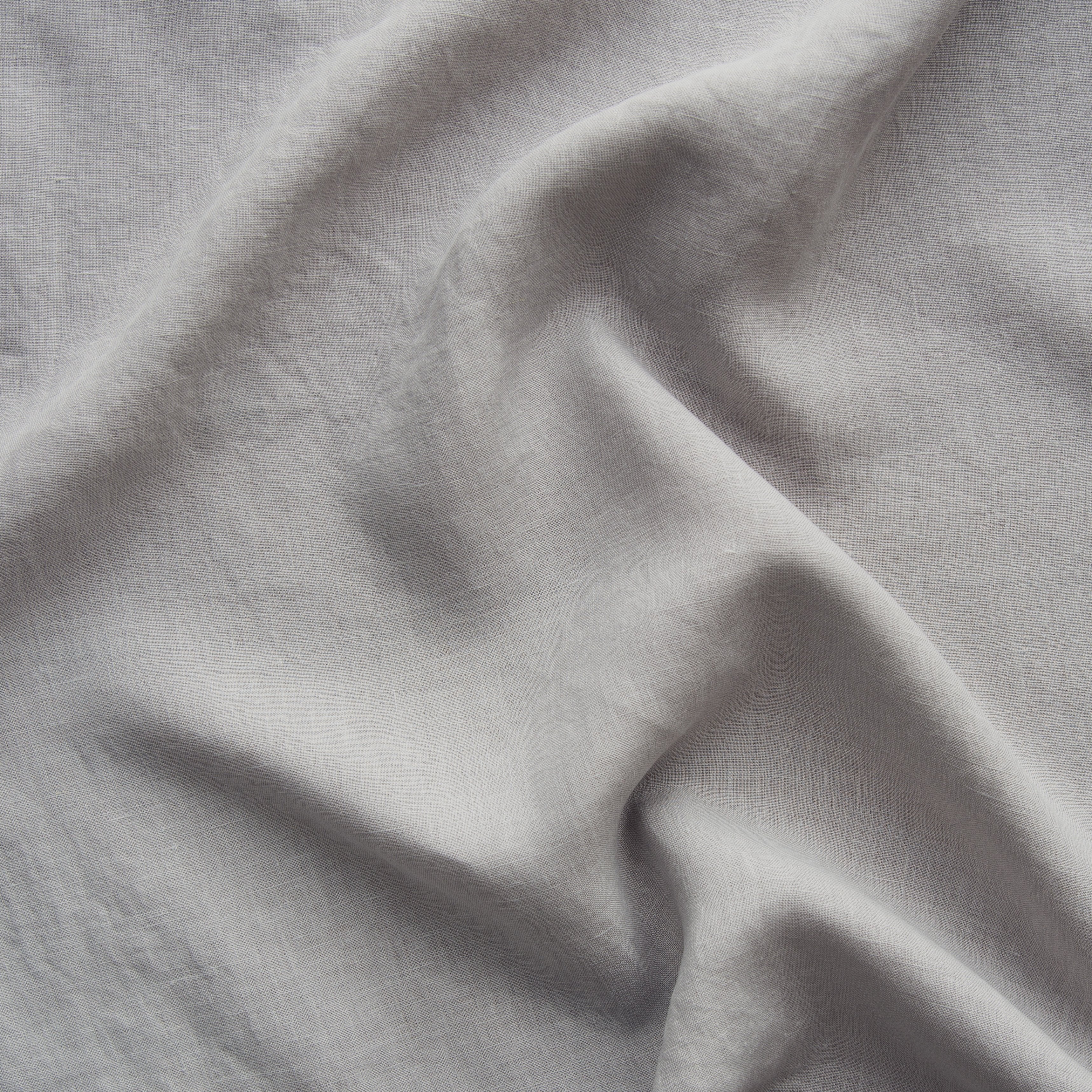 Fog: A close up of linen in fog, a neutral-warm, soft mid-tone grey. 