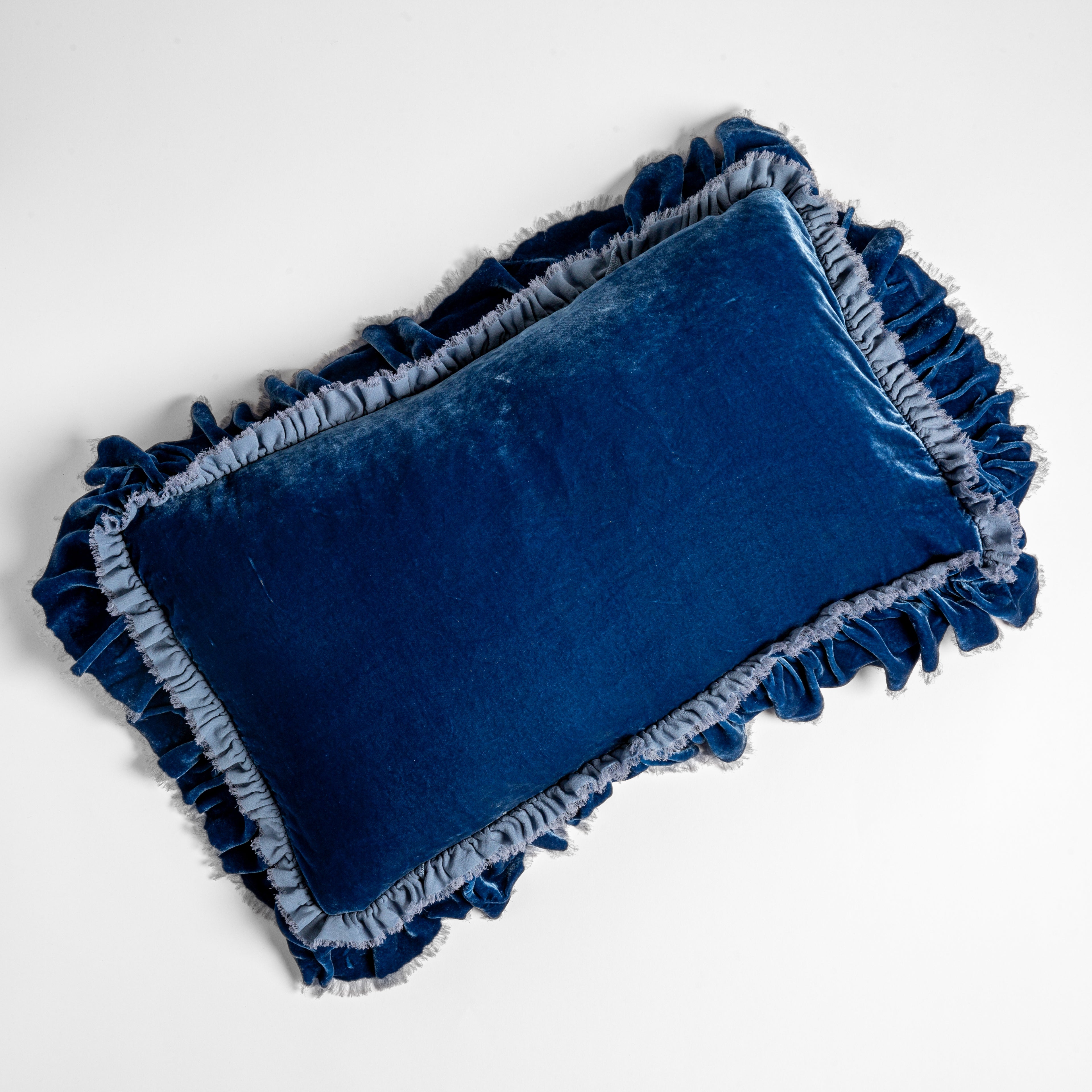 Tahoe Blue: overhead shot of a 15x24 silk velvet pillow with a raw edge ruffle detail. 