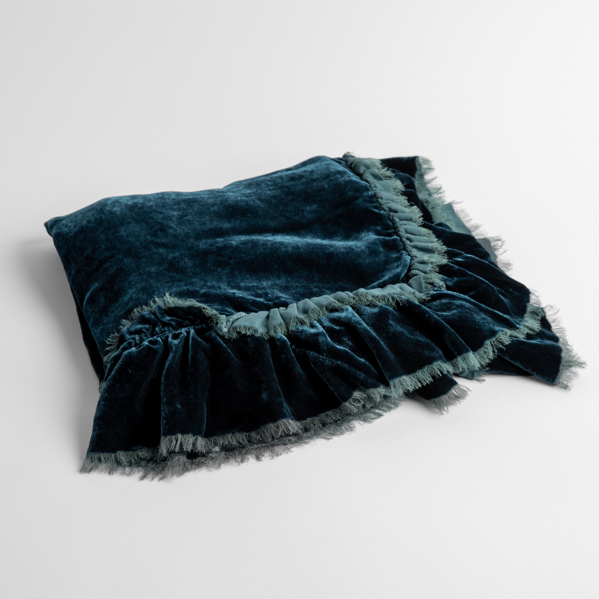 Cenote:  an overhead shot of a folded silk velvet baby blanket with a raw-edged eyelash ruffle detail.