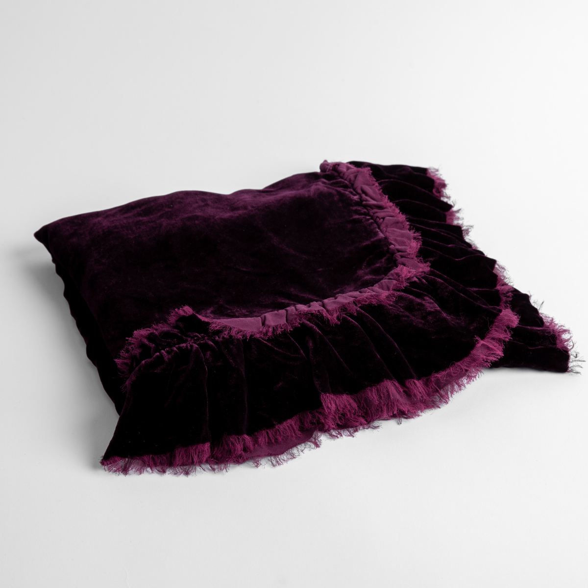 Fig:  an overhead shot of a folded silk velvet baby blanket with a raw-edged eyelash ruffle detail.
