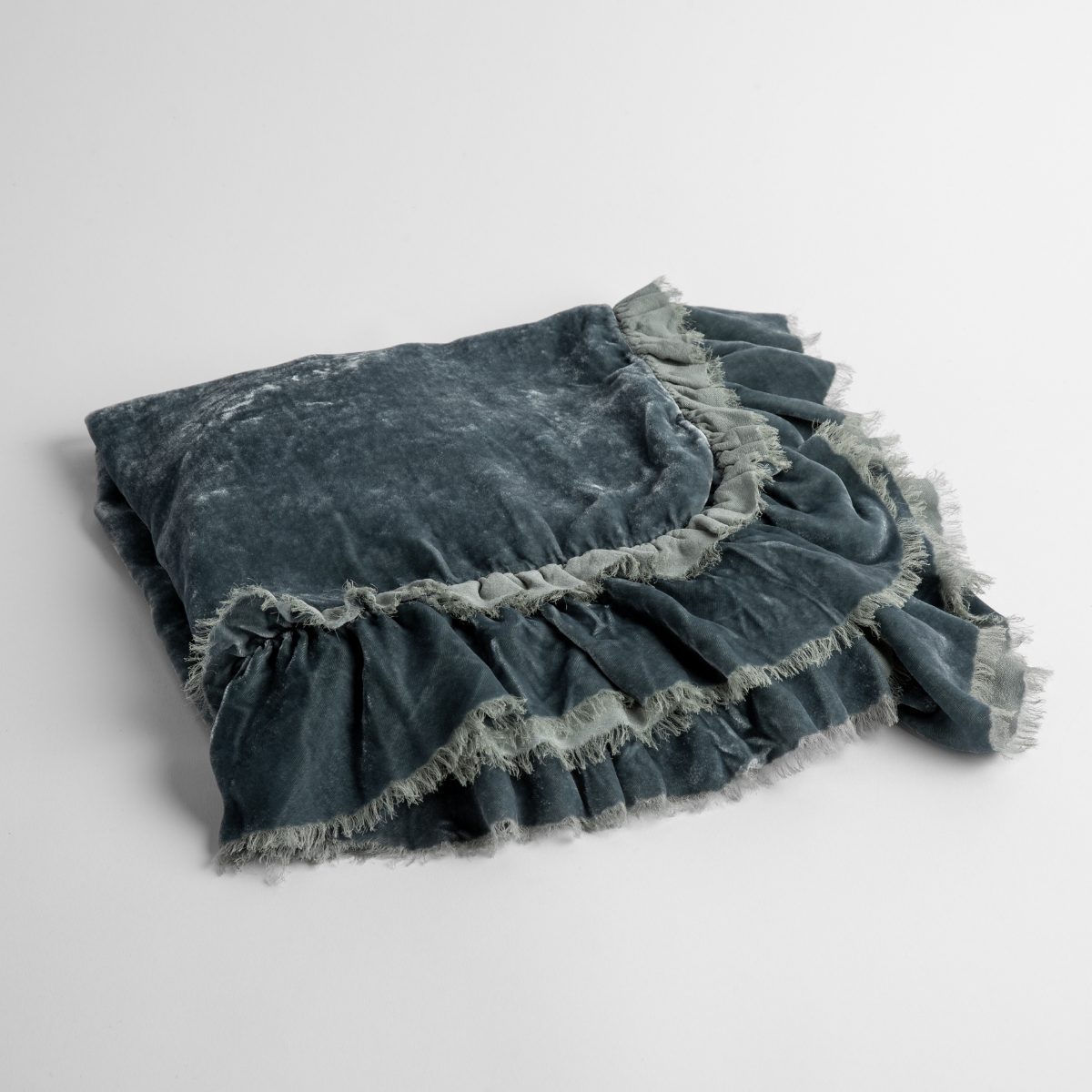 Mineral:  an overhead shot of a folded silk velvet baby blanket with a raw-edged eyelash ruffle detail.