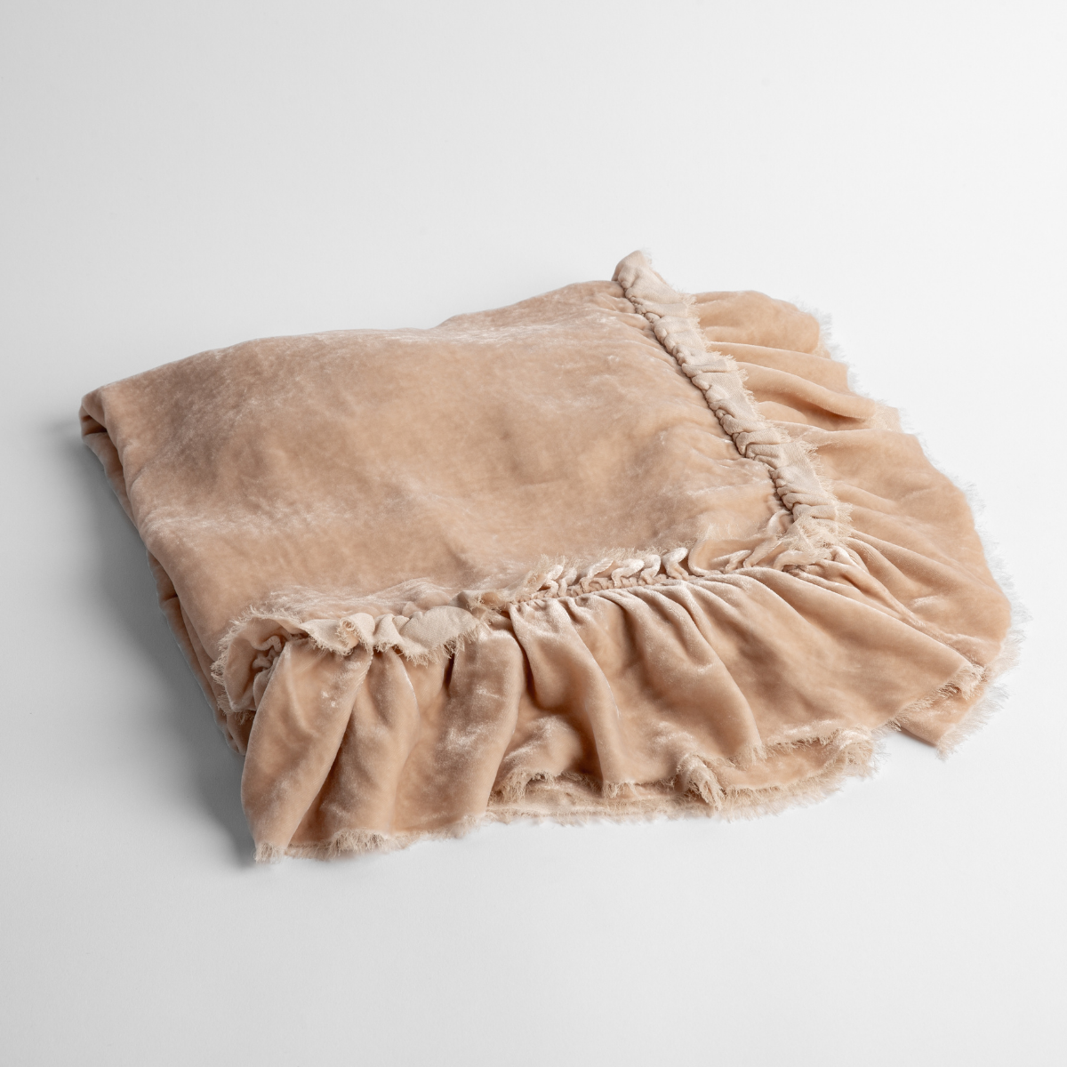 Pearl:  an overhead shot of a folded silk velvet baby blanket with a raw-edged eyelash ruffle detail.