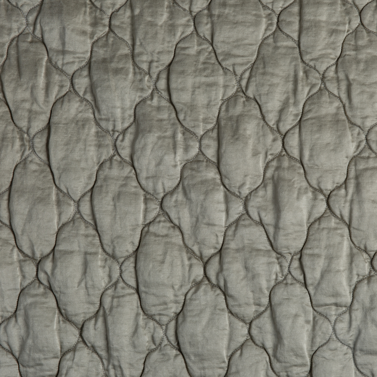 Fog: A close up of quilted charmeuse fabric in fog, a neutral-warm, soft mid-tone grey.