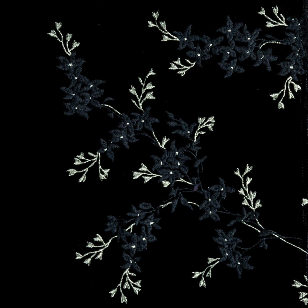 Corvino: A close up of embroidered silk velvet fabric in Corvino, a black tone.
