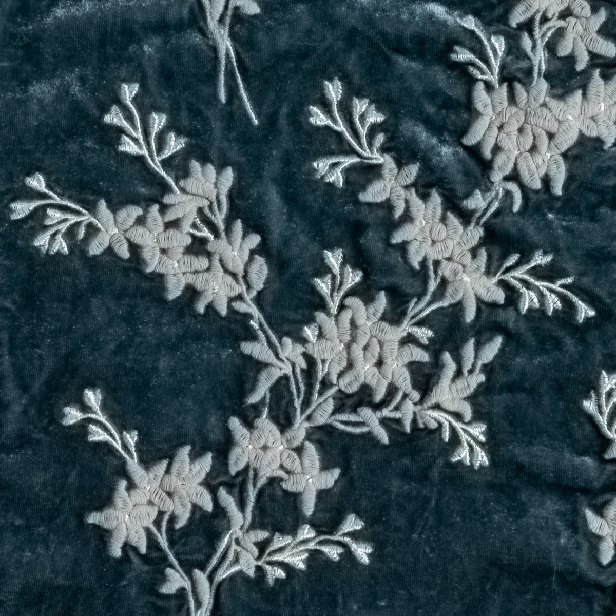 Mineral: A close up of embroidered silk velvet fabric in mineral, a soothing seafoam blue with subtle grey-green undertones.
