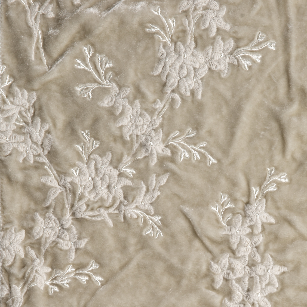 Parchment: A close up of embroidered silk velvet fabric in parchment, a warm, antiqued cream.