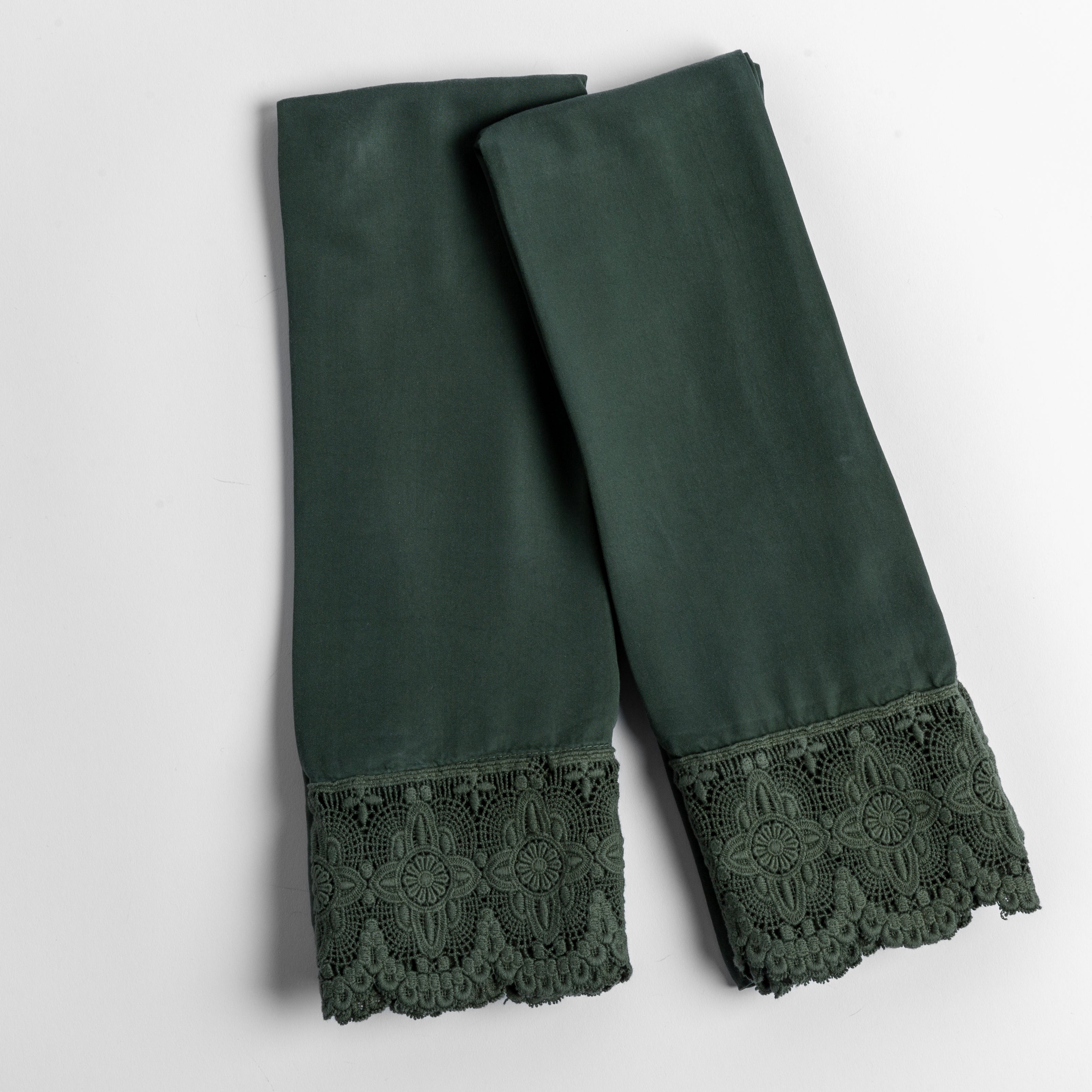 cotton lace trimmed tencel pillowcases folded and shot from overhead against a white background