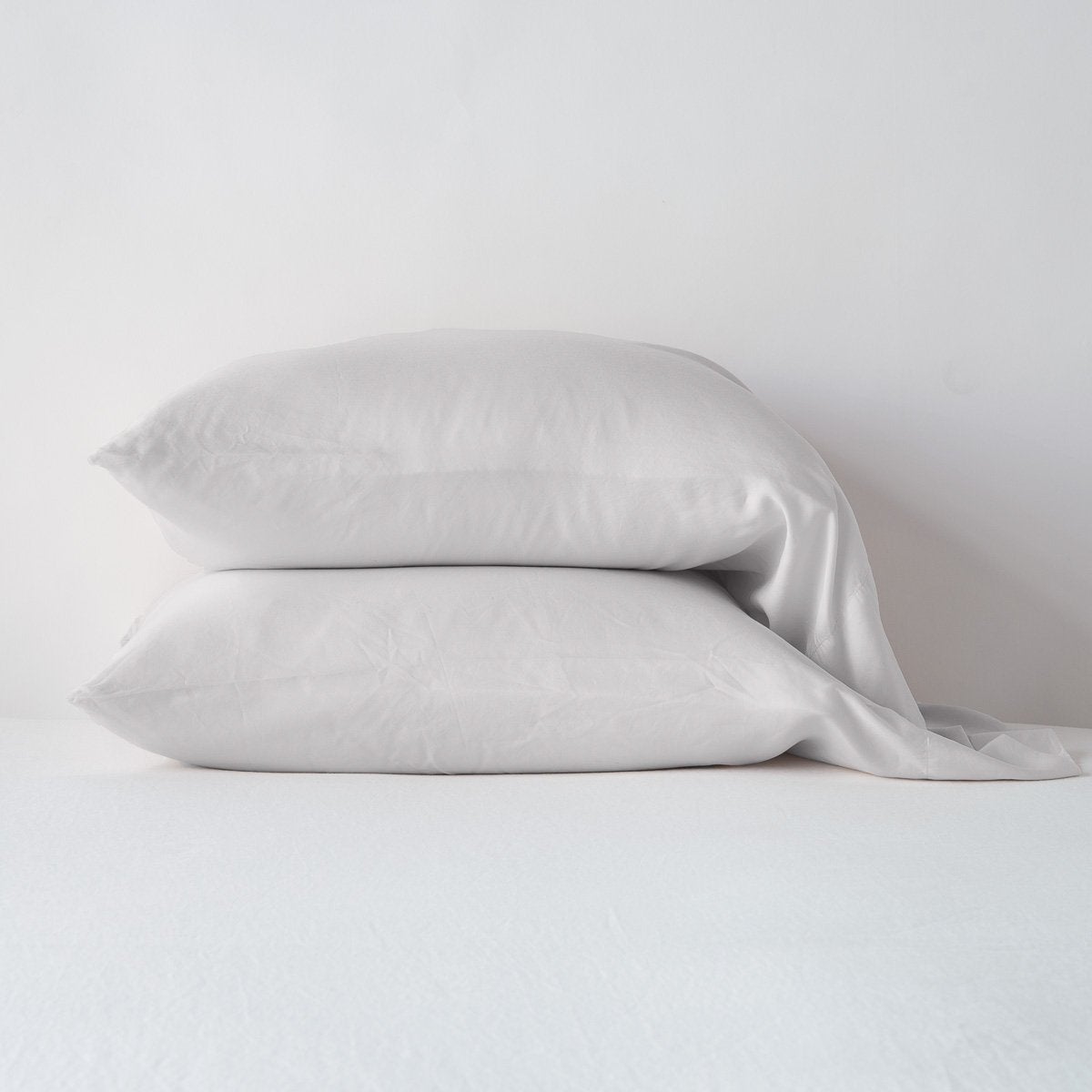 Sterling: sleeping pillows stacked neatly against a white backdrop - side view.