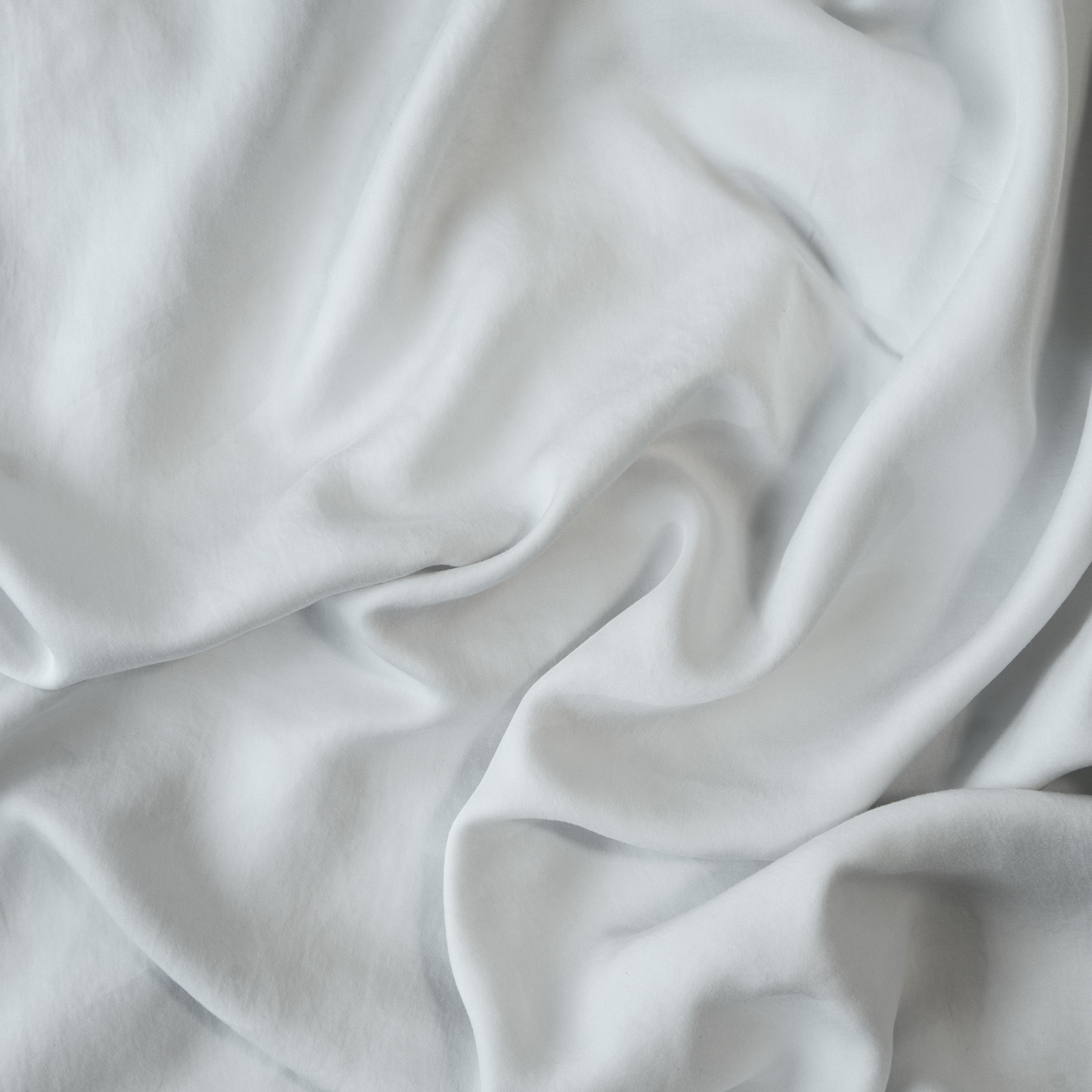 Cloud: A close up of Tencel™ fabric in cloud, a soft, subtle sky blue-grey. 