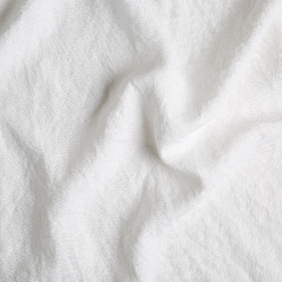White: A close up of midweight linen fabric in classic white.
