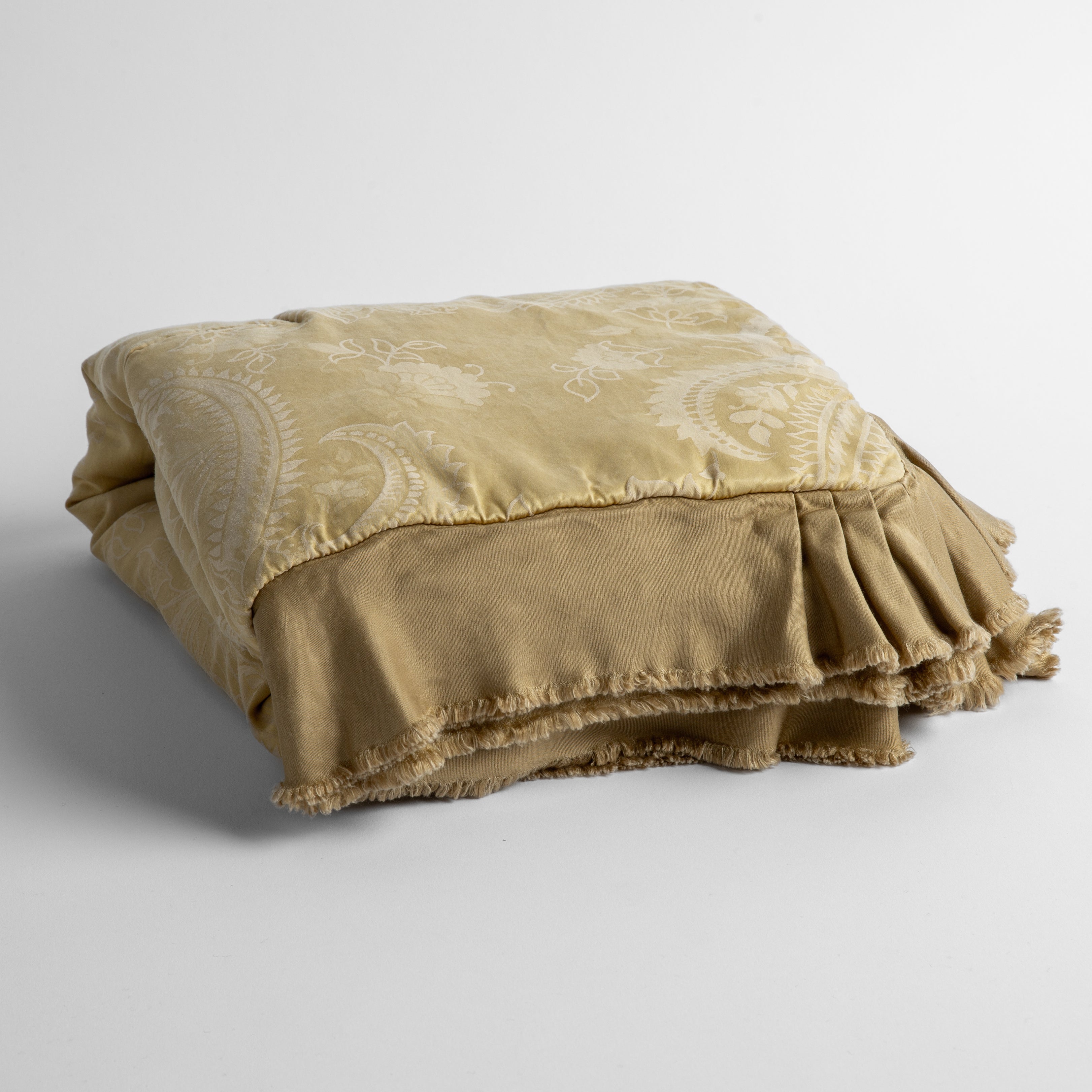 Honeycomb: a silk and tencel™ jacquard baby blanket folded and shot against a white background with the ruffled trim situated to be visible