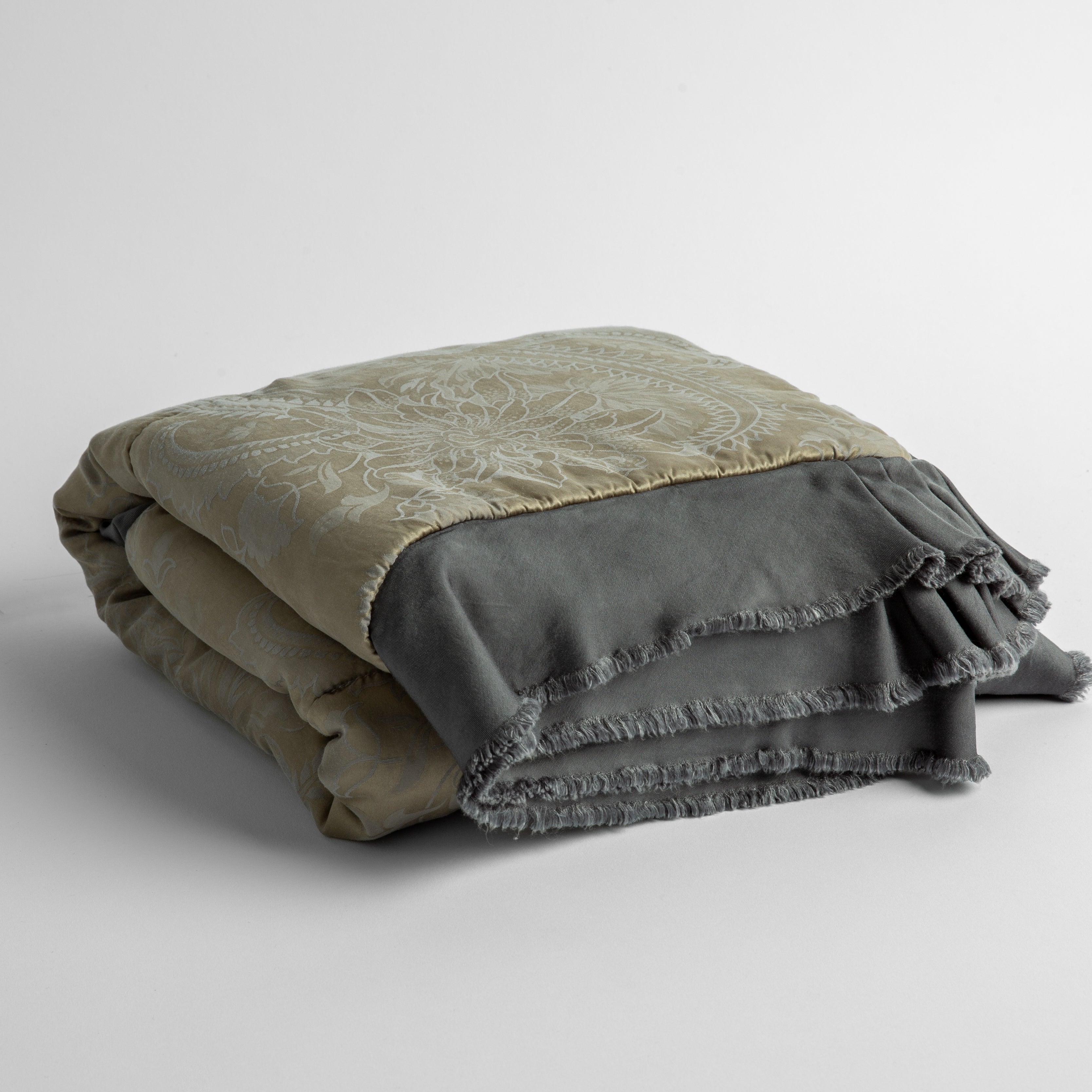 Moonlight:  silk and tencel™ blend jacquard baby blanket folded and shot from a slight overhead angle to show the trim detail against a white background.