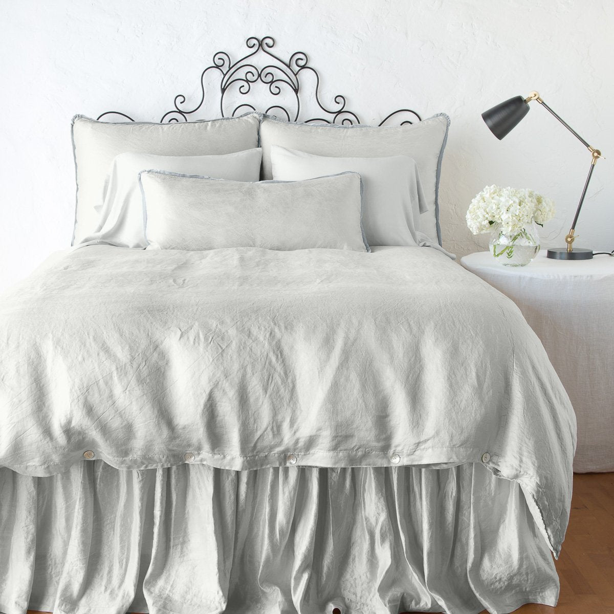 Sterling: duvet cover with matching pillows and bed skirt - end of bed view.