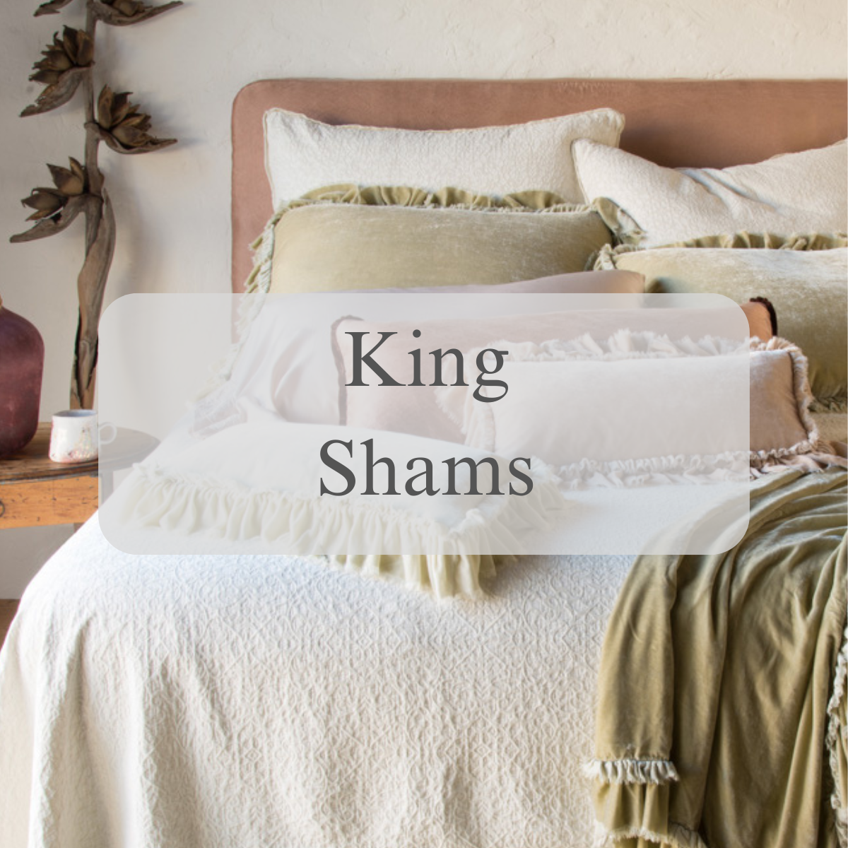 A shot of shams and pillows in light neutral tones with a text overlay that reads King Shams