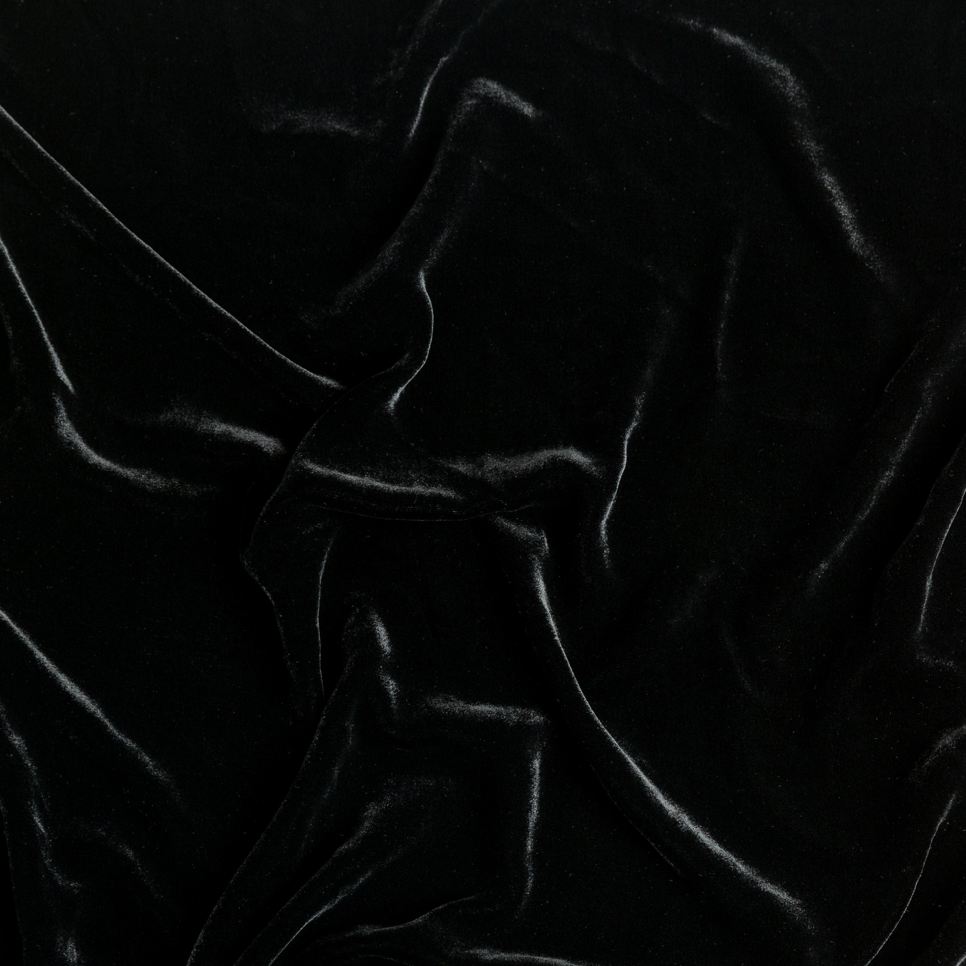 Corvino: A close up of silk velvet fabric in Corvino, a black tone.