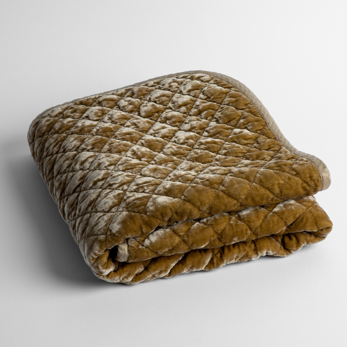 Honeycomb:   a folded quilted silk velvet baby blanket shown from overhead to showcase quilting  pattern and texture. 