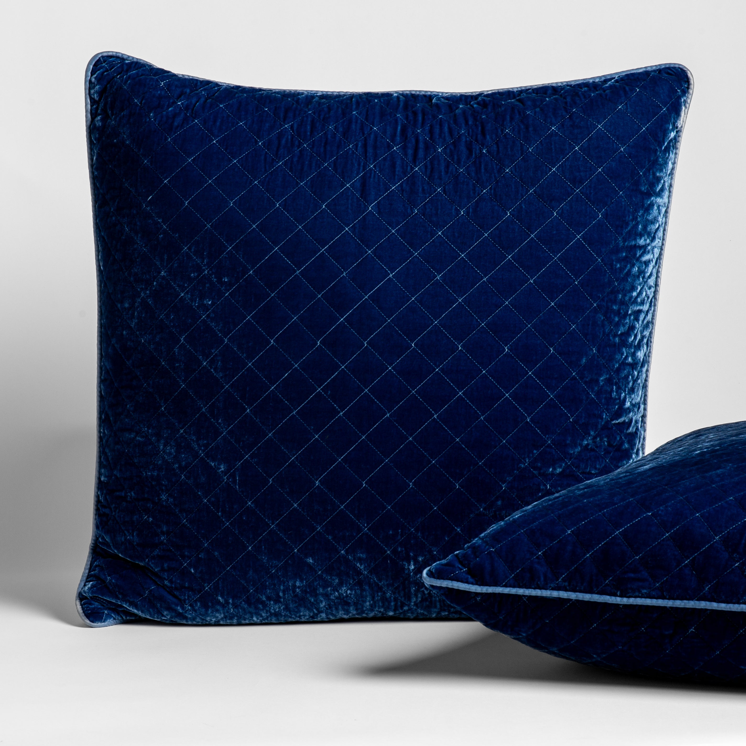 Tahoe Blue: 2 square Silk Velvet Quilted Throw Pillows in Tahoe Blue, a saturated blue like a crystal clear sky, shown against a white background. 