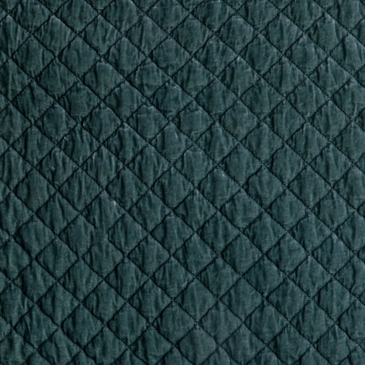 Eucalyptus: A close up of quilted silk velvet fabric in eucalyptus, a soft light green.