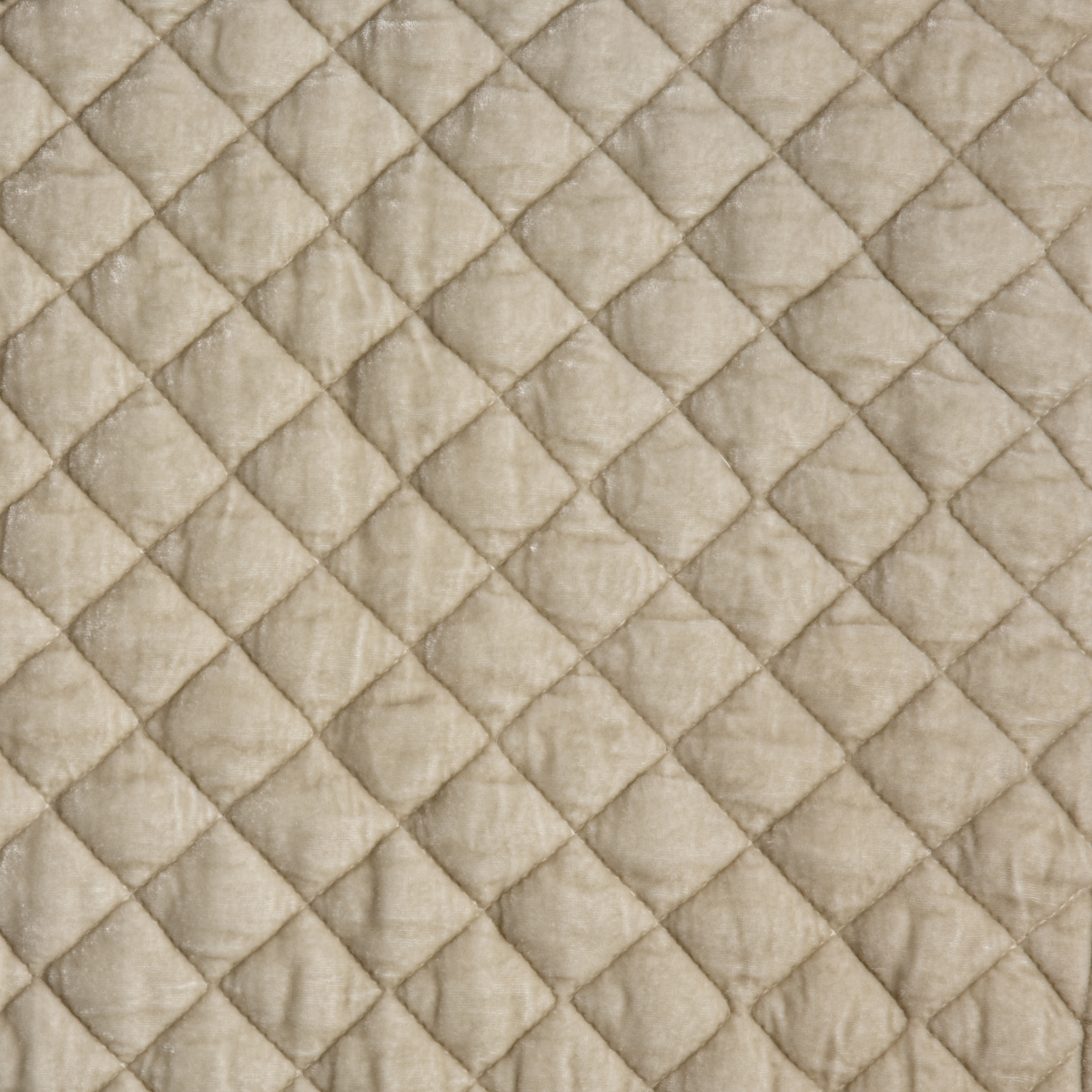 Parchment: A close up of quilted silk velvet fabric in parchment, a warm, antiqued cream.