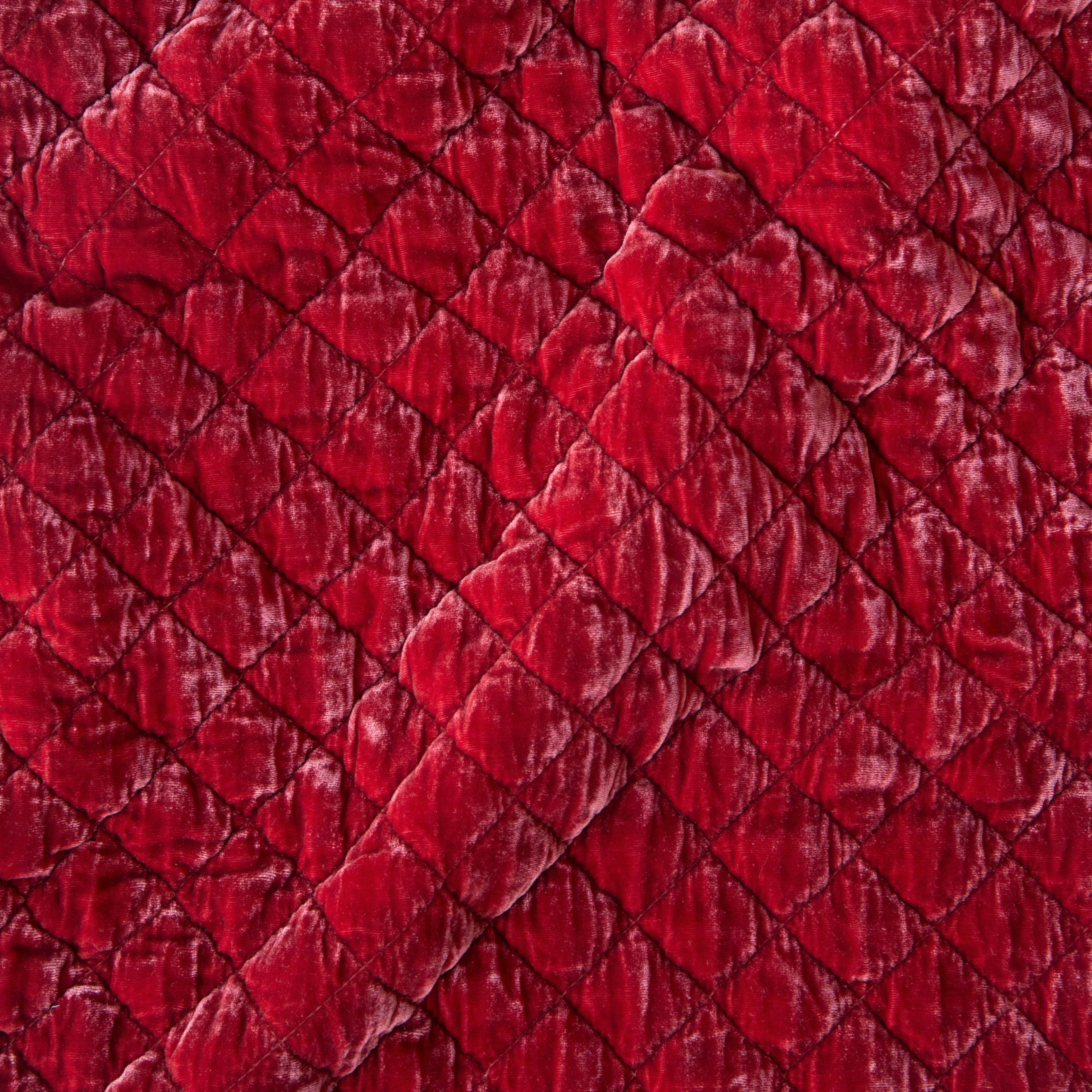 Poppy: A close up of quilted silk velvet fabric in poppy, a warm coral pink.