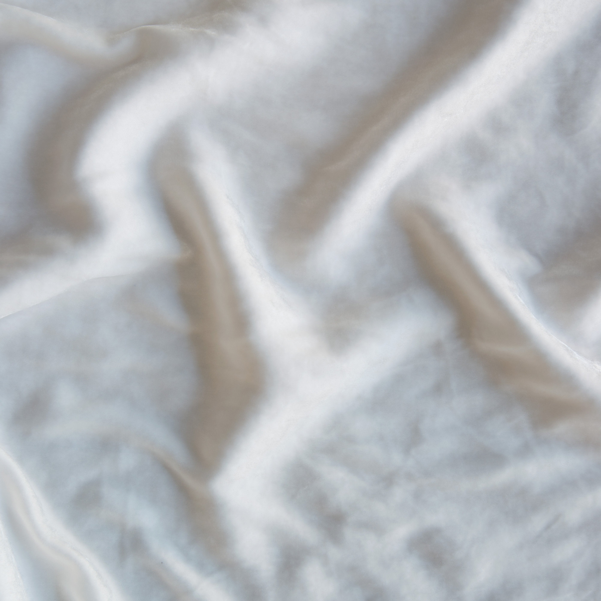 Winter White: A close up of silk velvet fabric in winter white, softer and warmer in tone than classic white.