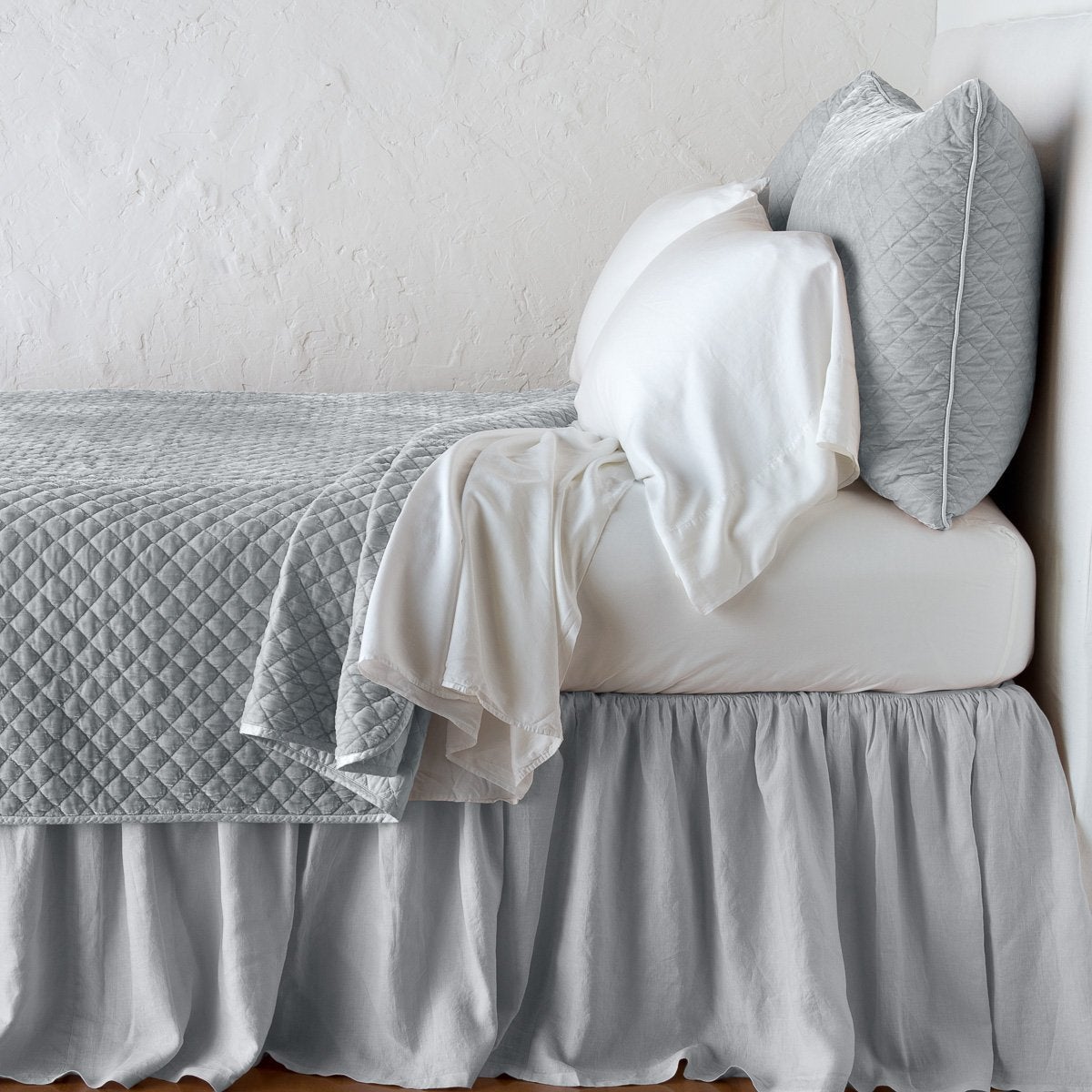 Sterling: shams with matching coverlet and white sheeting - side view.