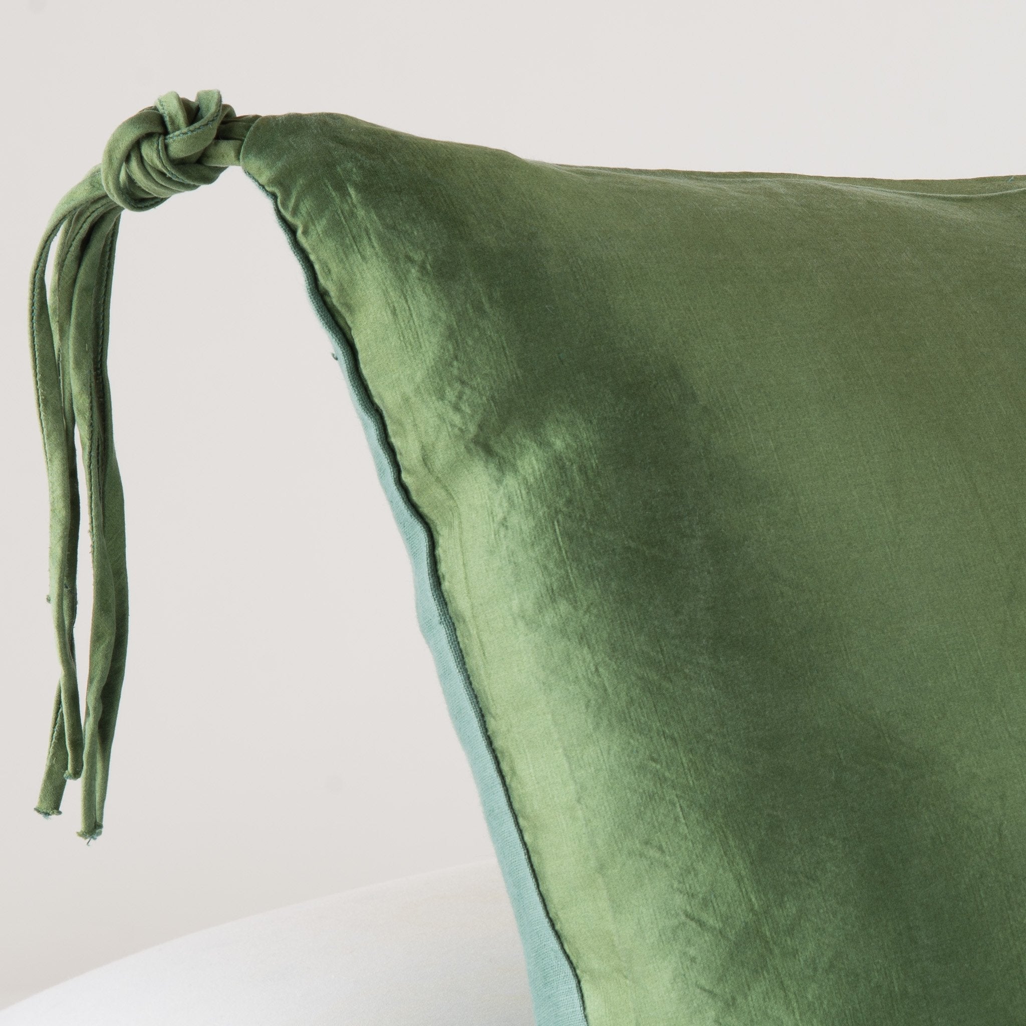 Jade: Corner detail close-up, highlighting hand-tied charmeuse tassel.