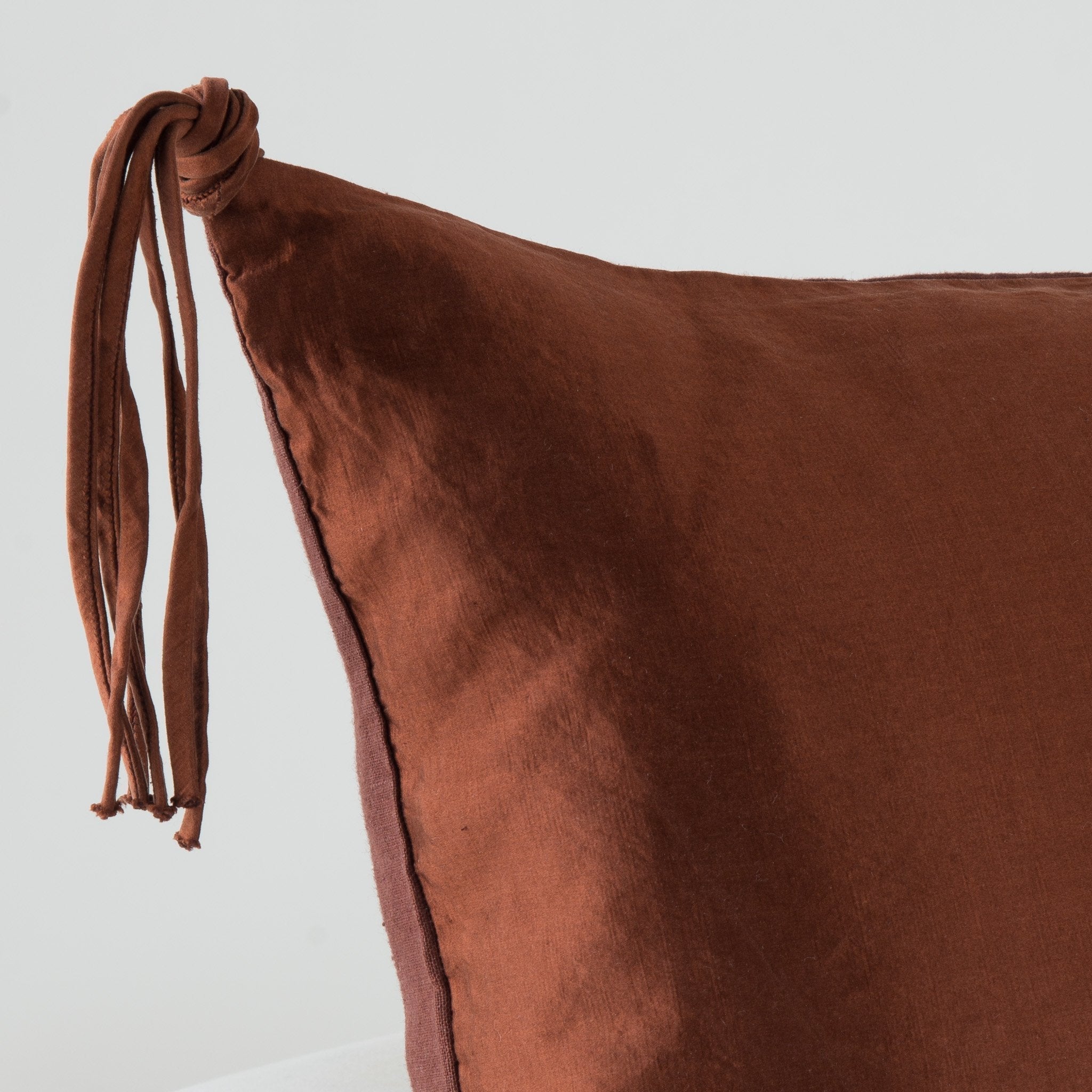 Mahogany: Corner detail close-up, highlighting hand-tied charmeuse tassel.