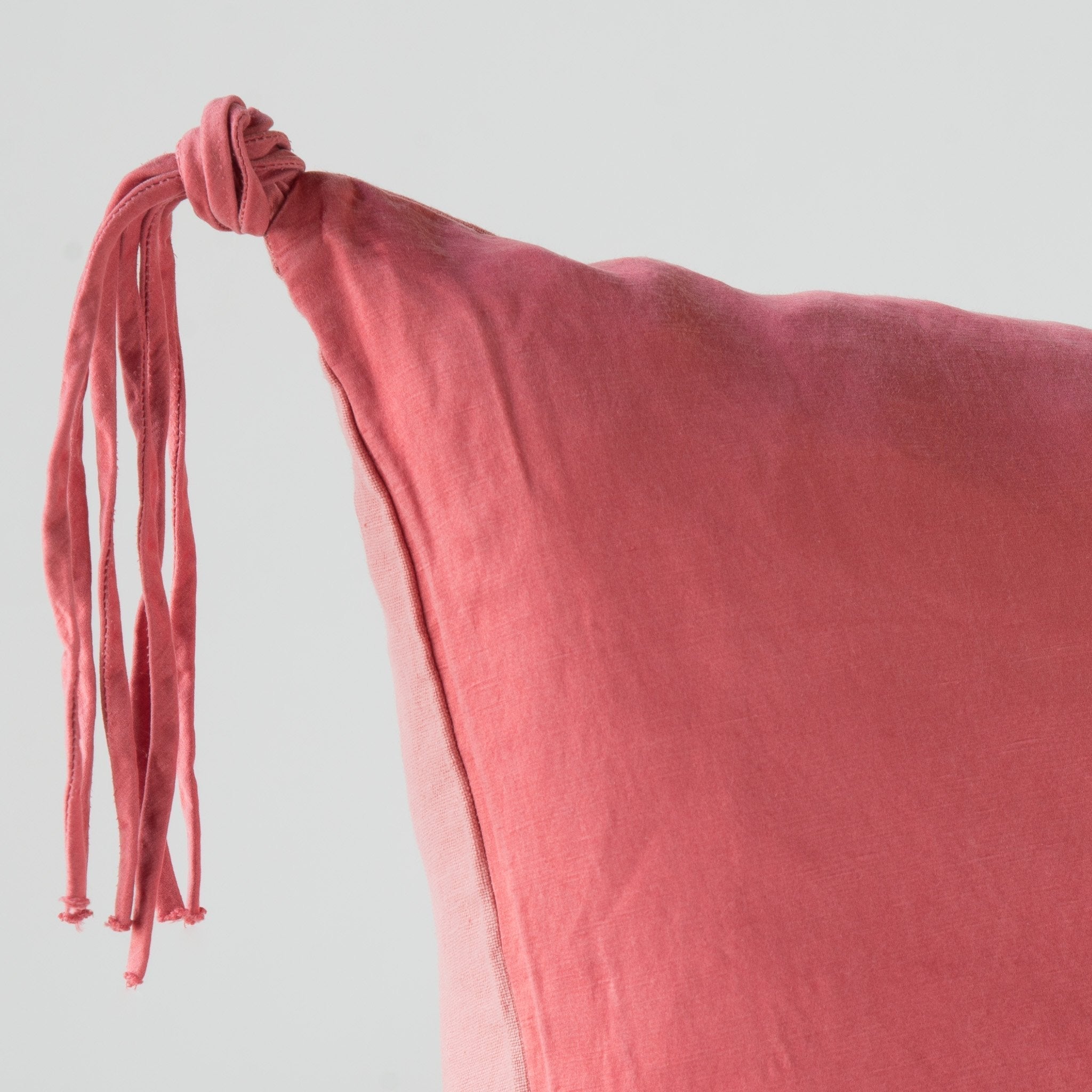 Poppy: Corner detail close-up, highlighting hand-tied charmeuse tassel.