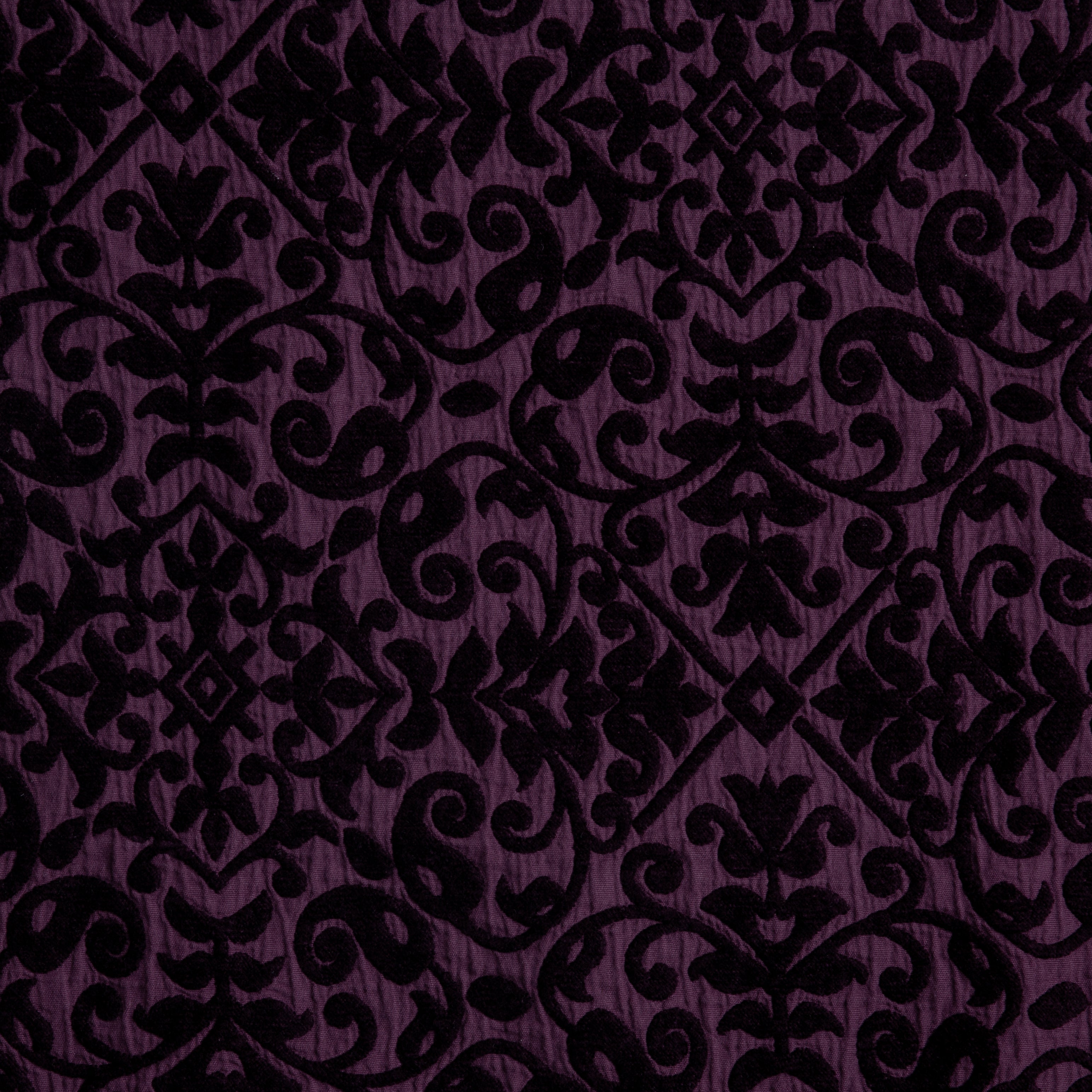 Fig: A close up of cotton chenille fabric in fig, a richly saturated purple-garnet.