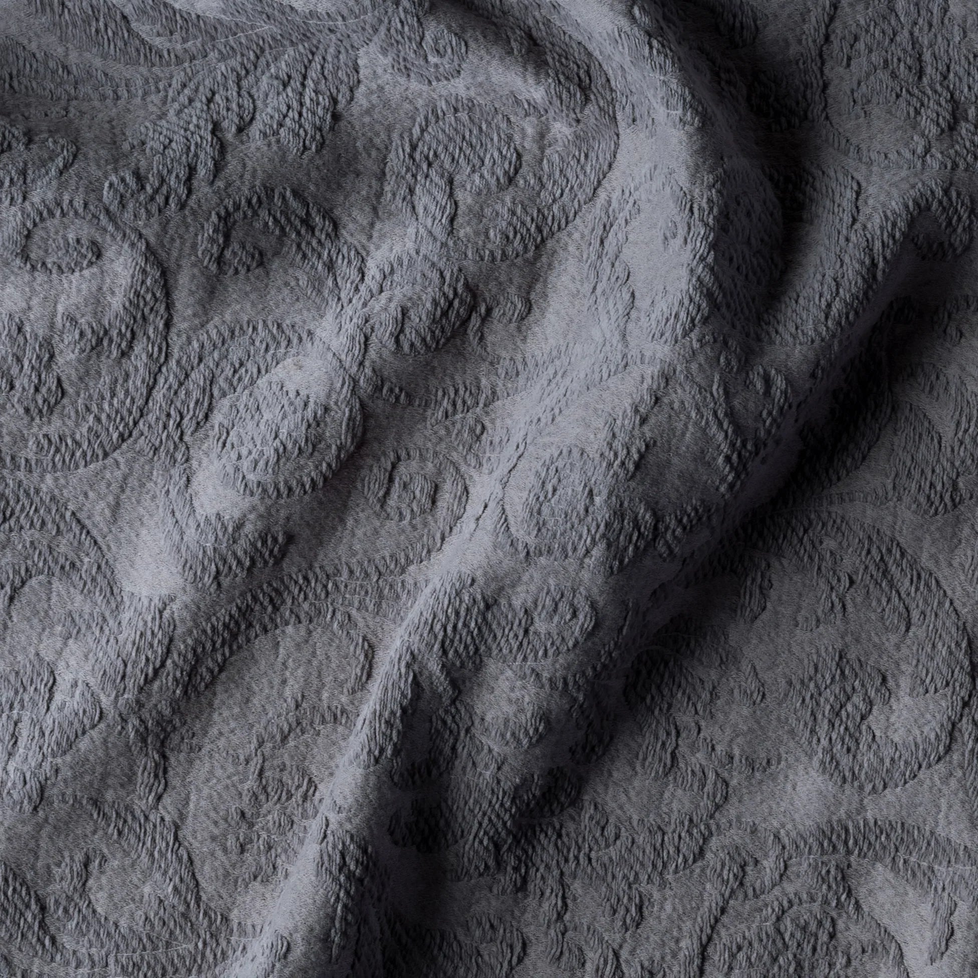 Moonlight: A close up of Adele fabric in moonlight, a saturated, cool, mid-dark grey tone. The fabric is rumpled to show the cotton damask texture.