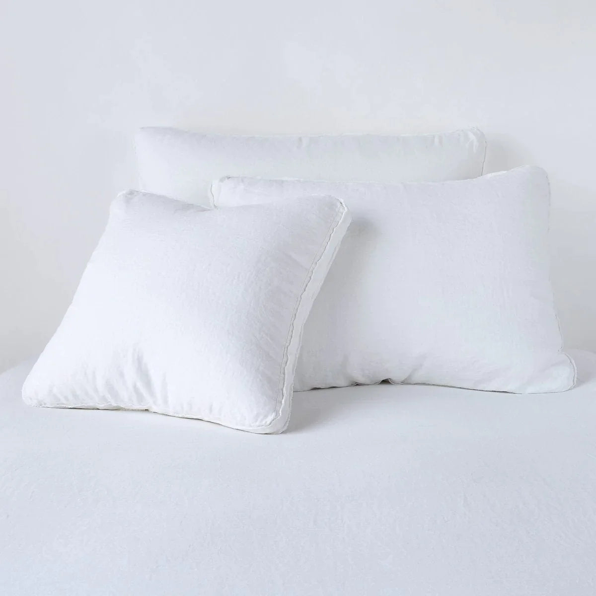 White: Midweight linen shams in white colorway shown leaning upright on white background.