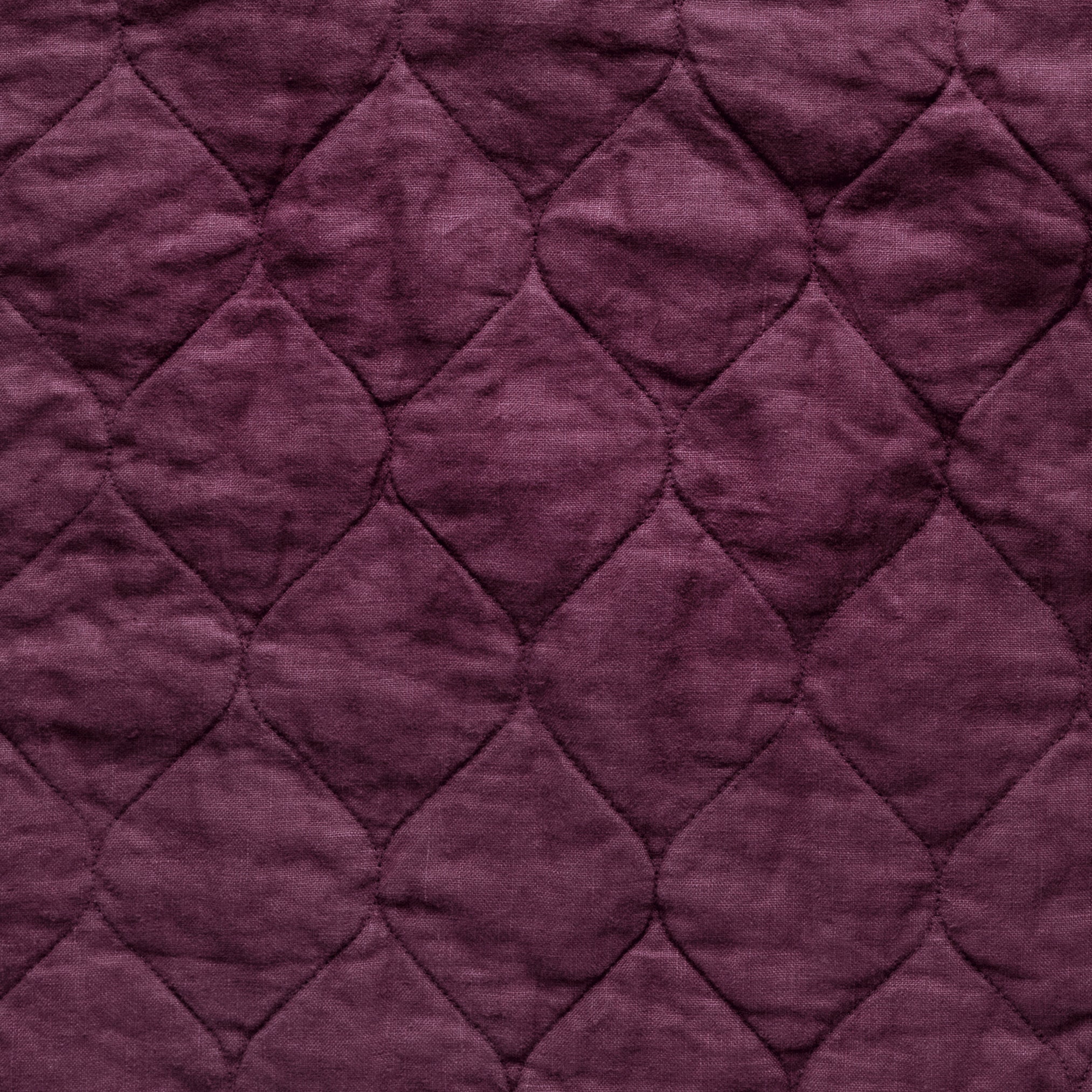 Fig: Close-up of Harlow cotton velvet quilting in fig, a richly saturated purple-garnet. 