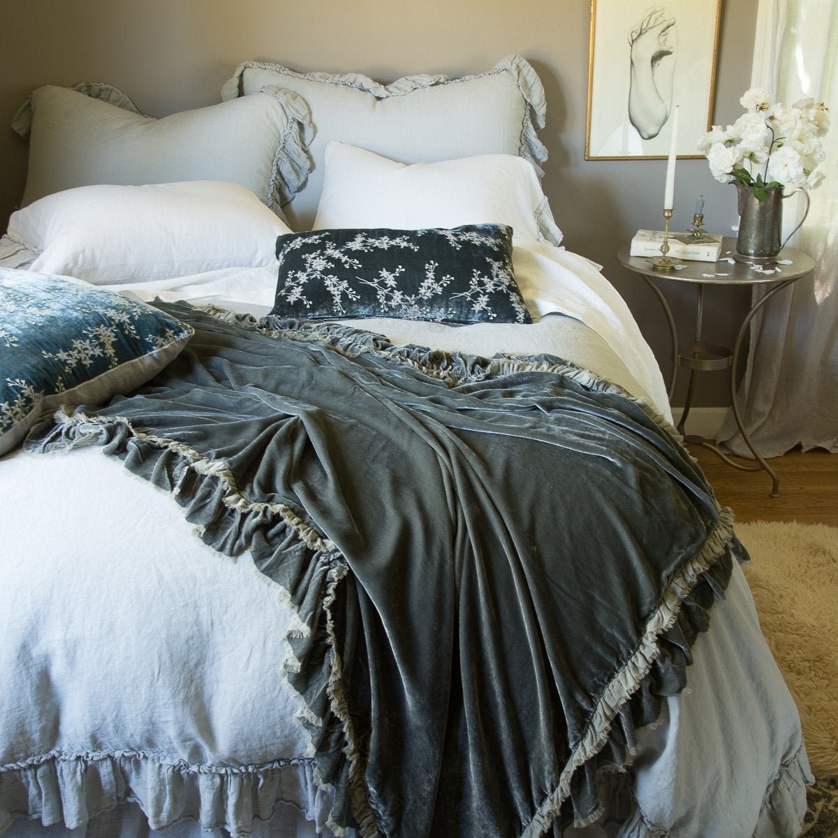 [allvariants]: Linen Whisper shams in mineral, layered with matching duvet cover and richly colored silk velvet accessory pieces - end of bed view.