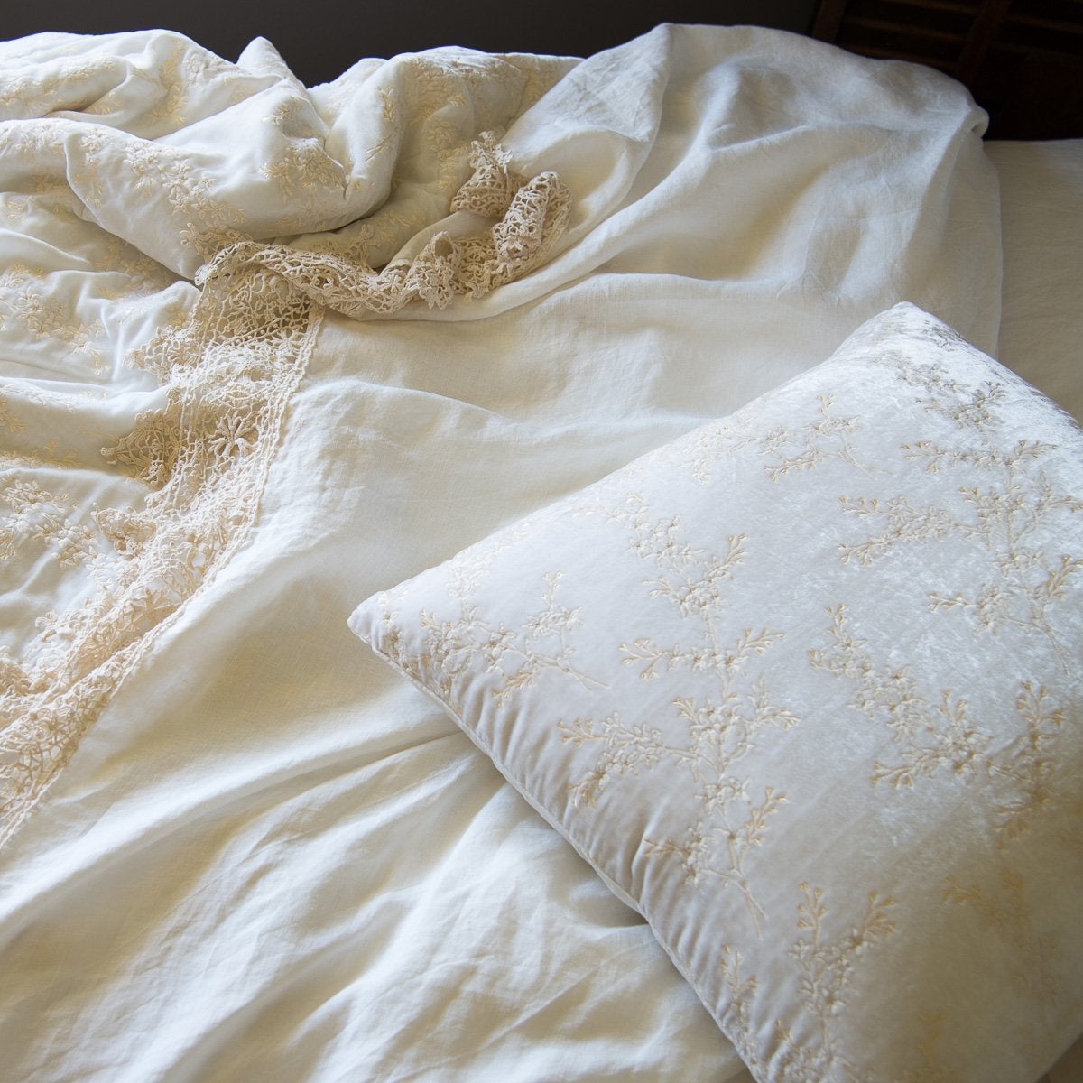 : Lynette's gold embroidery in winter white beautifully complements our linen with cotton lace in the same hue - close-up overhead angle.