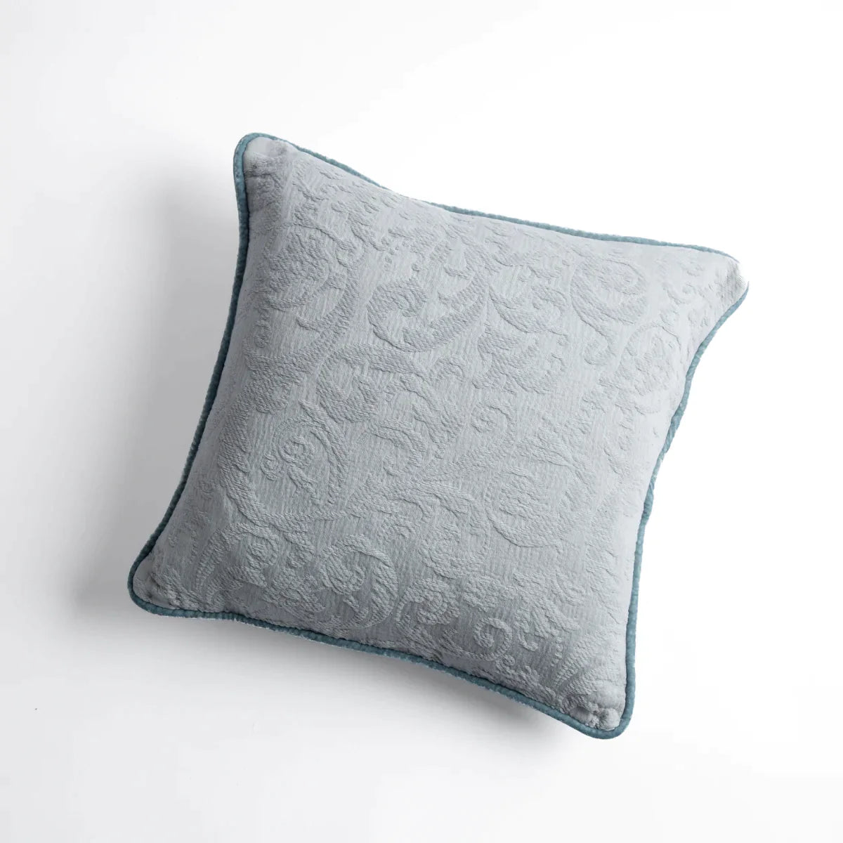 Cloud: Organic cotton damask square pillow with silk velvet trim on white background — overhead angle.