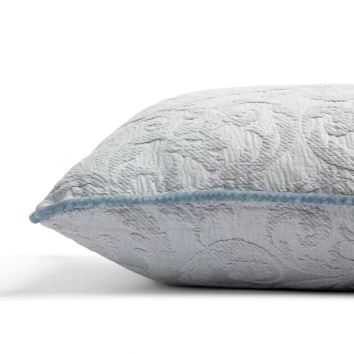 Cloud: Organic cotton damask square pillow with silk velvet trim on white background — side angle.