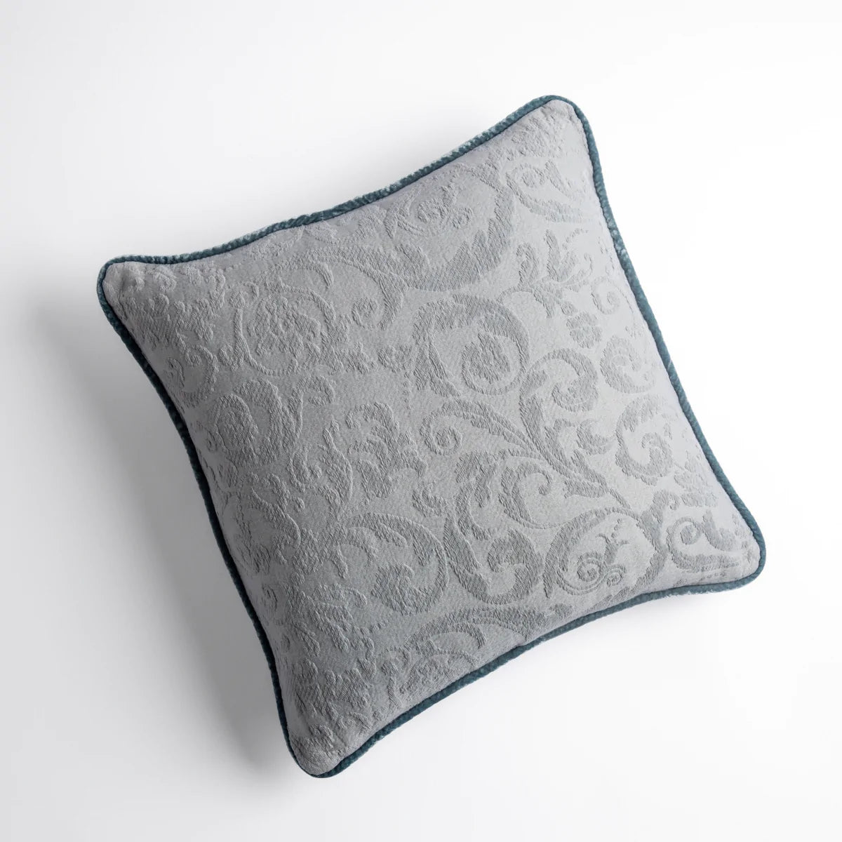 Mineral: Organic cotton damask square pillow with silk velvet trim on white background — overhead angle.