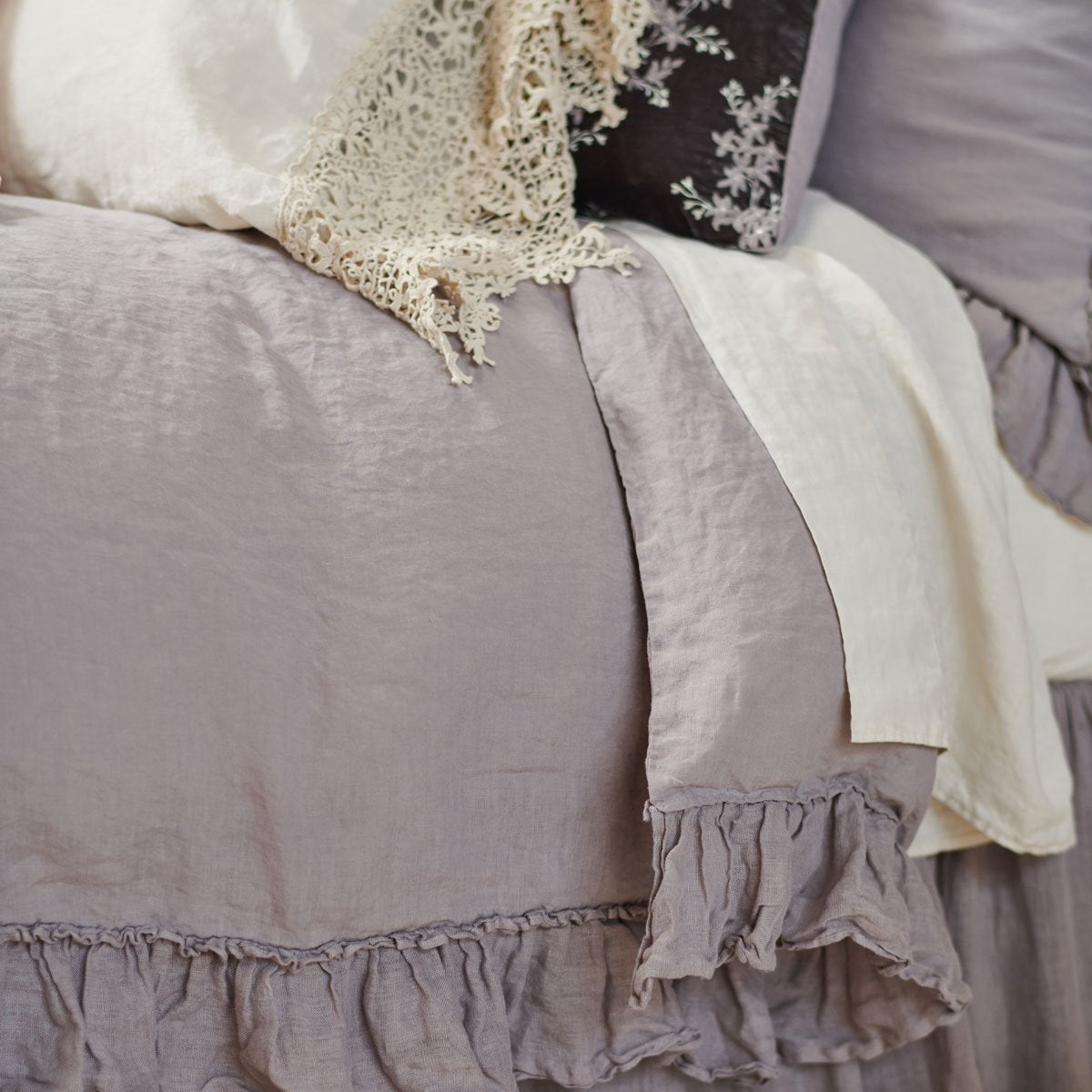 : Linen whisper duvet cover with parchment sheets and sleeping pillow - close-up three-quarter angle.