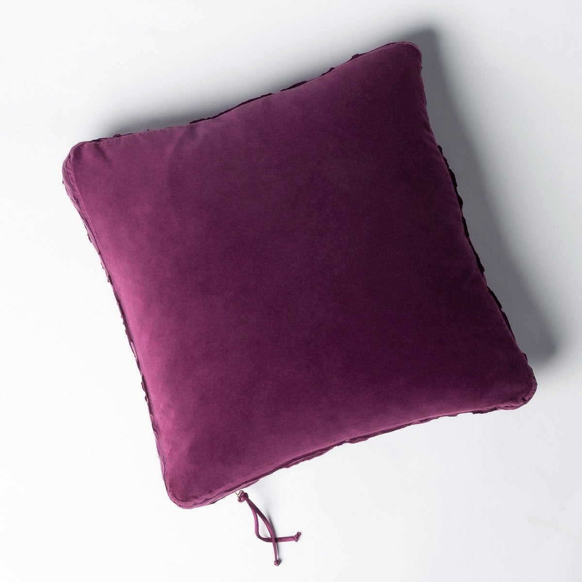 Fig: Cotton velvet 24 by 24 pillow on a plain background - overhead view.