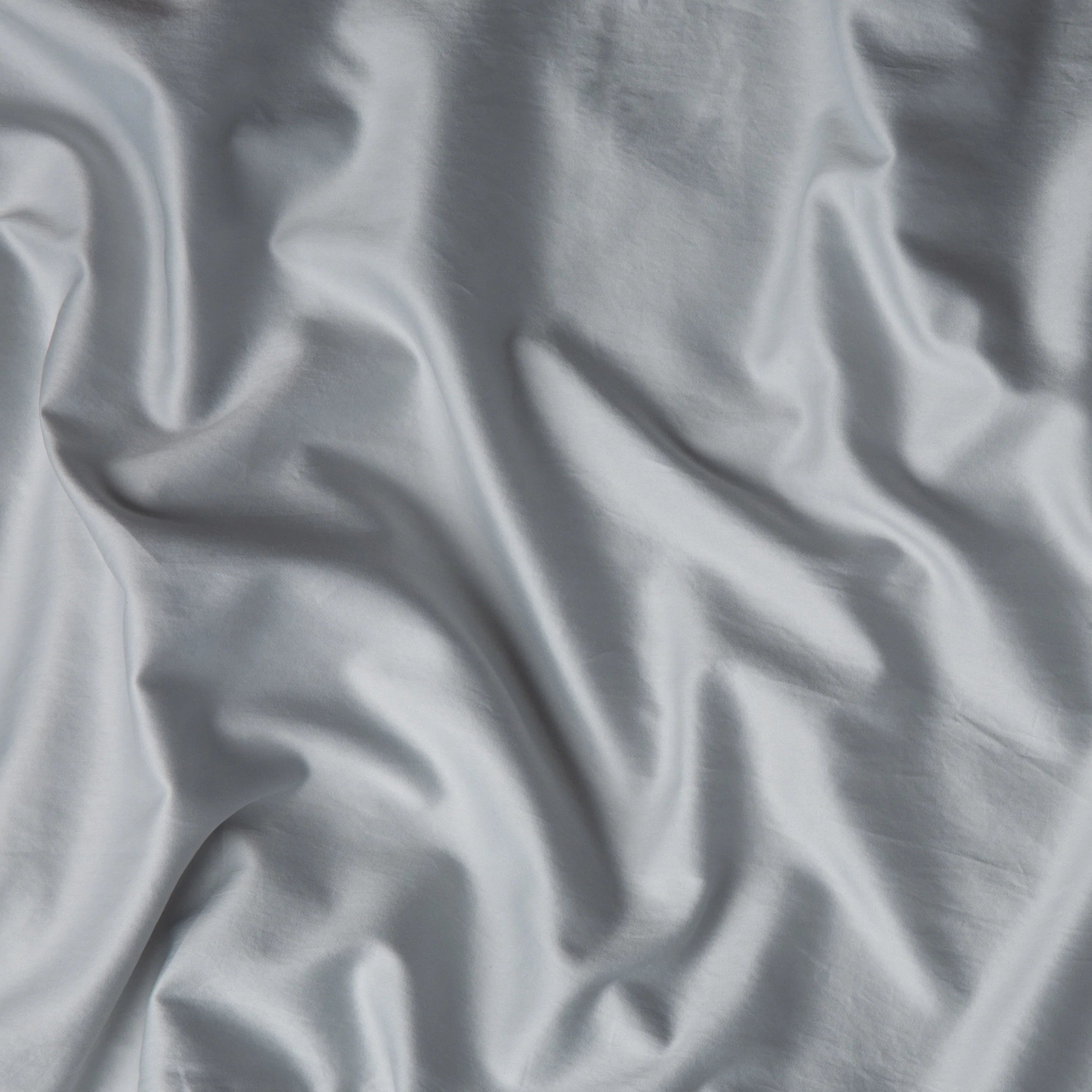 Cloud: A close up of cotton sateen fabric in cloud, a soft, subtle sky blue-grey. 