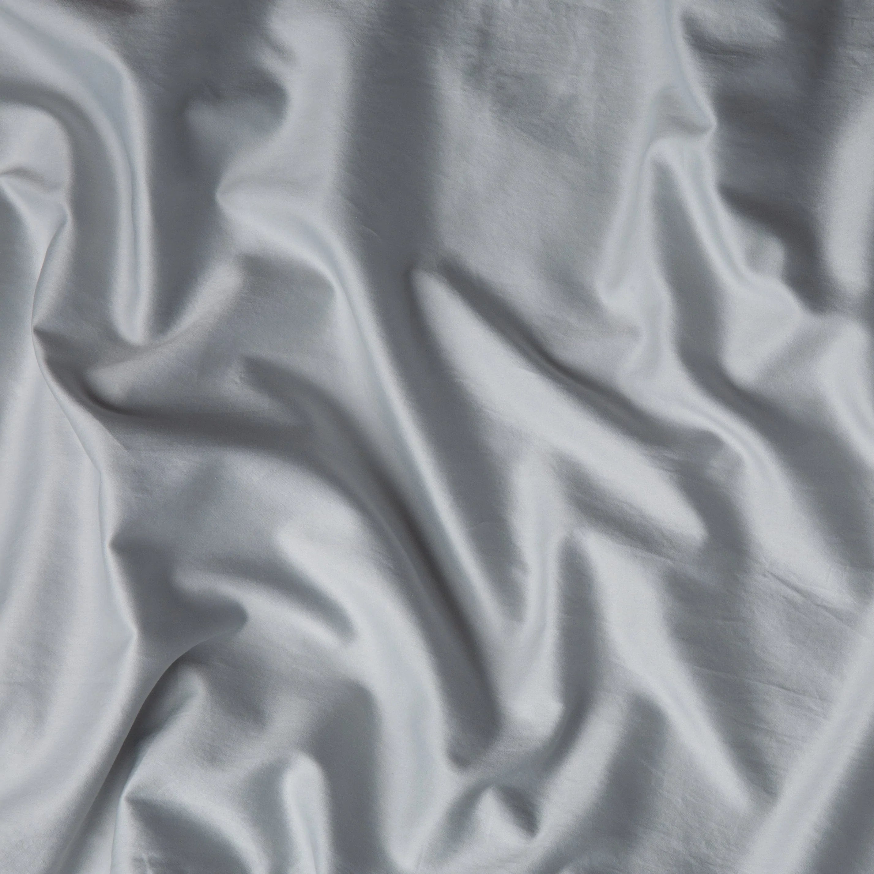 Cloud: A close up of cotton sateen fabric in sterling, a silvery neutral light grey. 