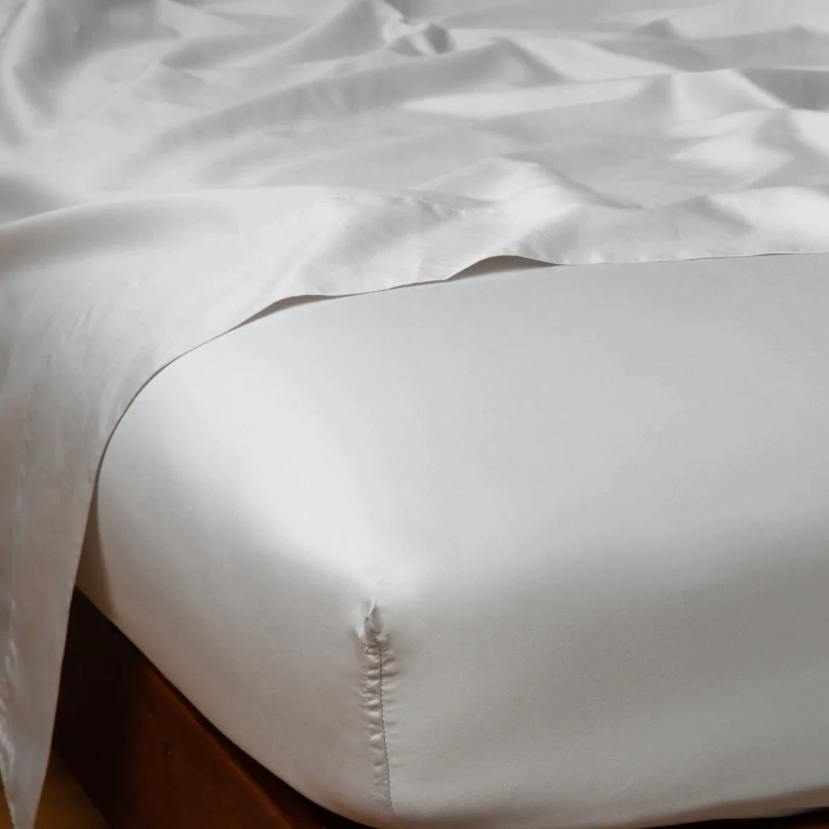 Sterling: Cotton sateen fitted sheet shown from the top corner, highlighting the shine of the fabric.