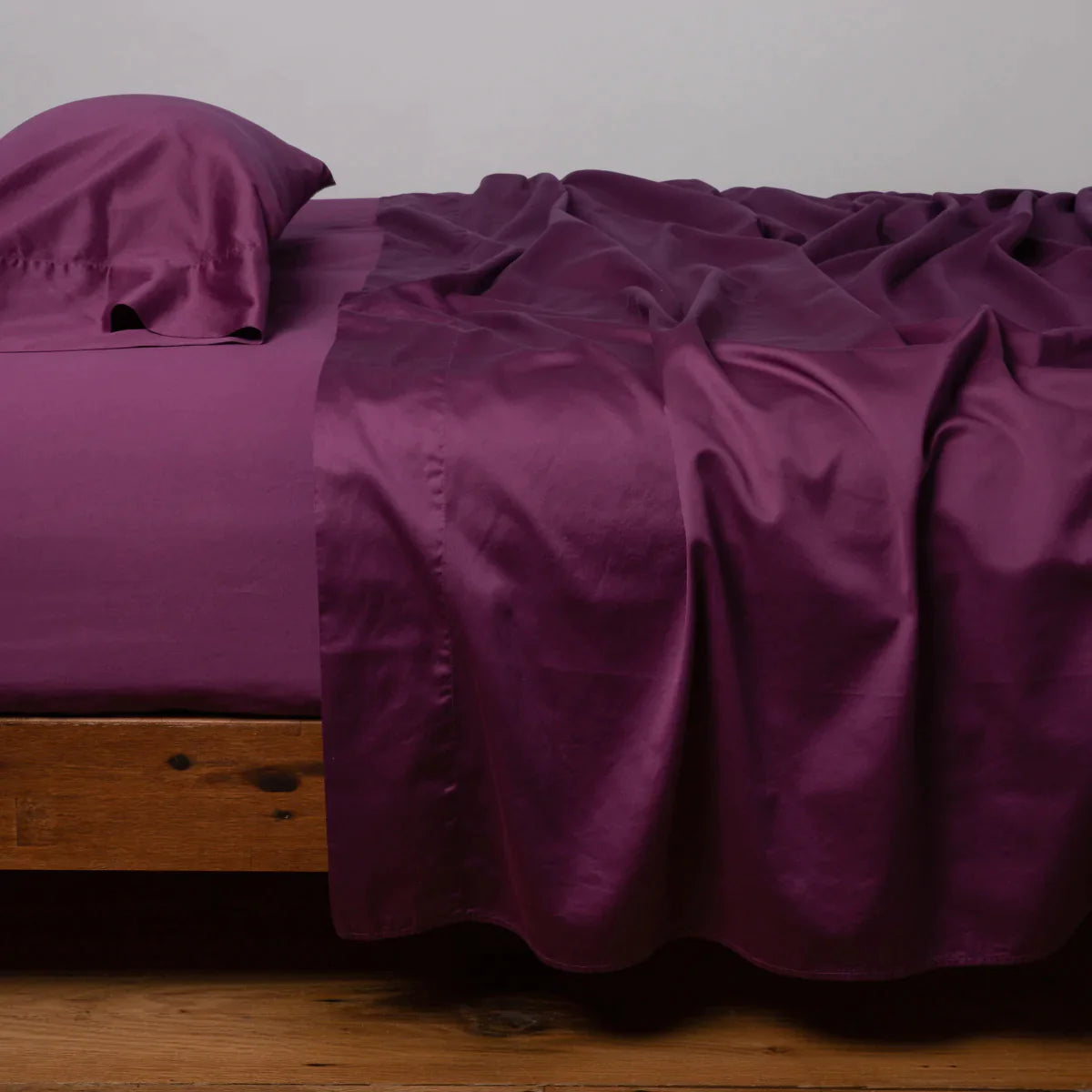 Fig: Cotton sateen flat sheet, shown with matching fitted sheet and sleeping pillow - side view.