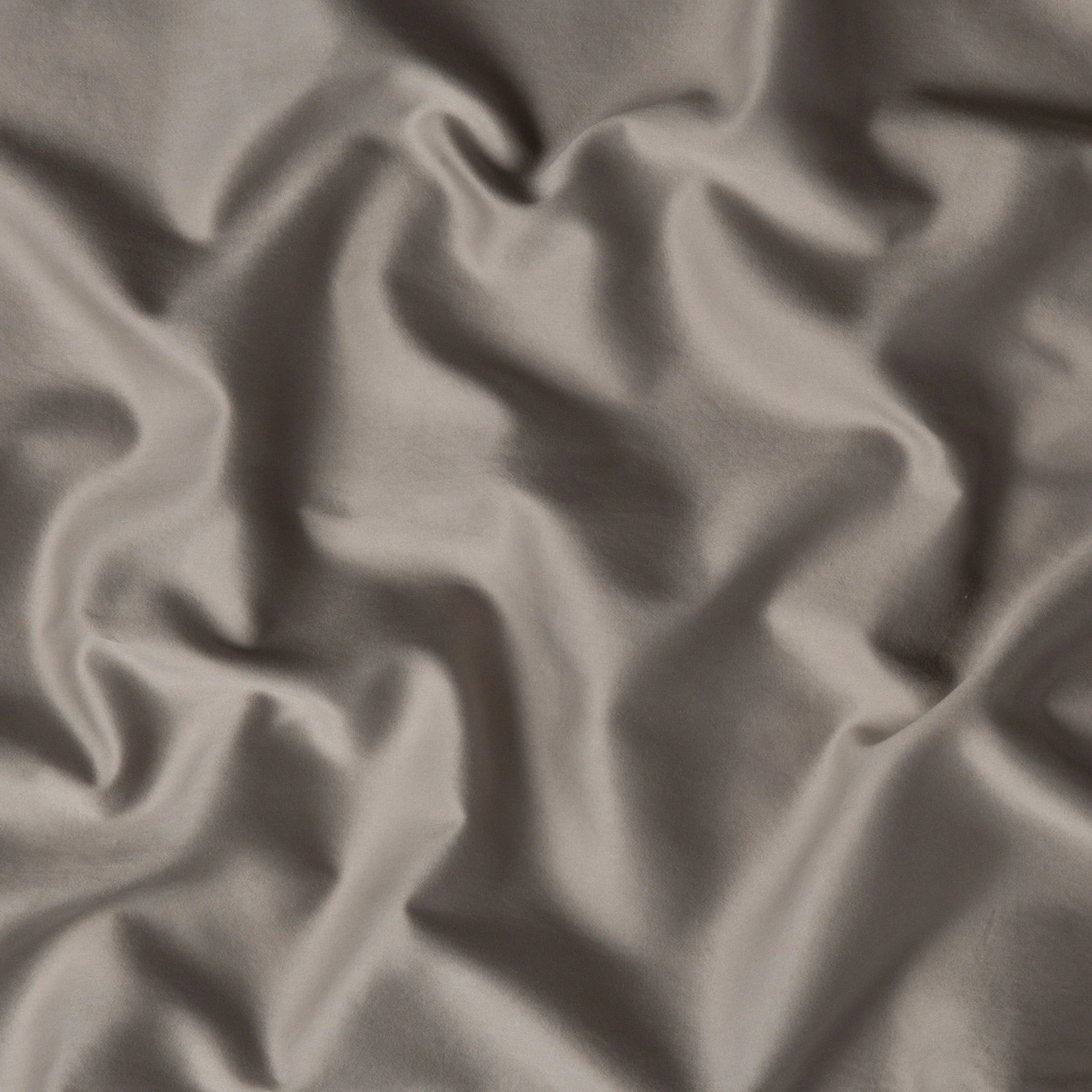 Fog: A close up of cotton sateen fabric in fog, a neutral-warm, soft mid-tone grey. 