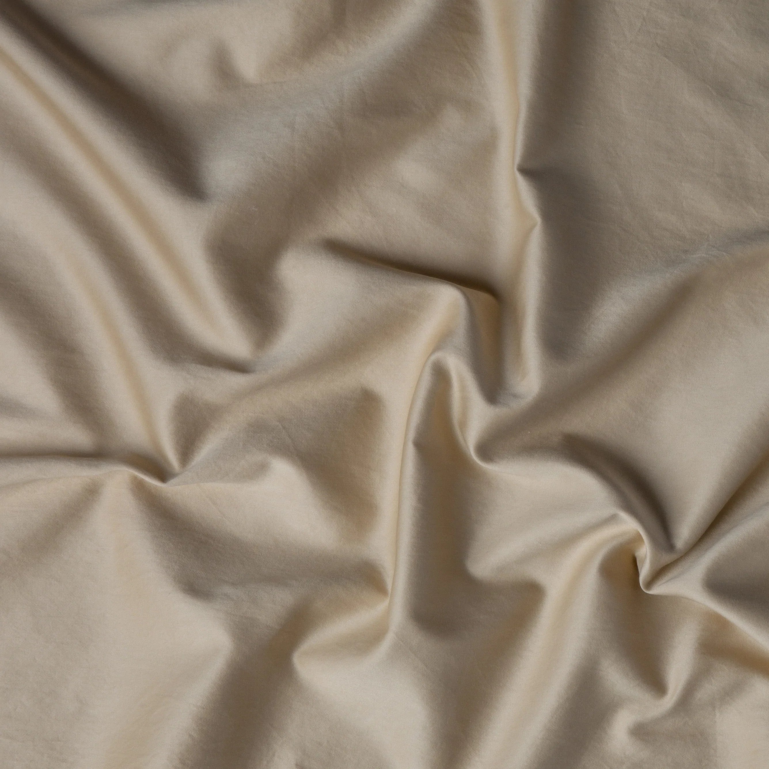 Honeycomb: A close up of cotton sateen fabric in honeycomb, a warm golden tone. 