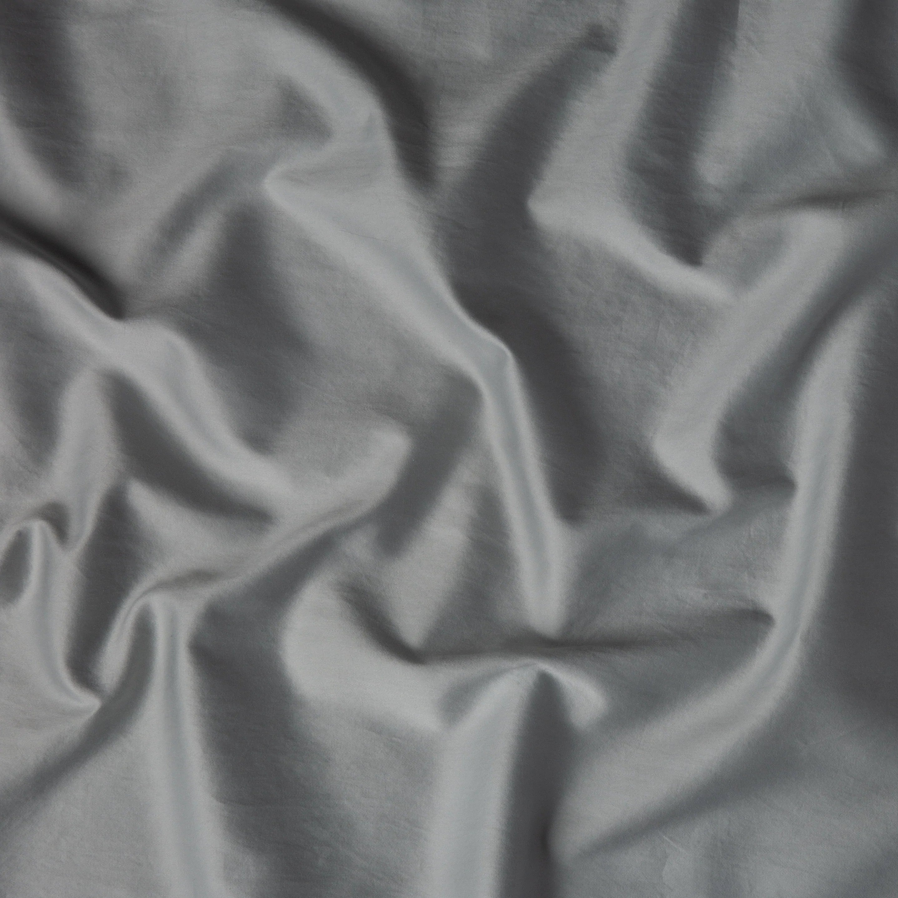 Mineral: A close up of cotton sateen fabric in mineral, a soothing seafoam blue with subtle grey-green undertones. 