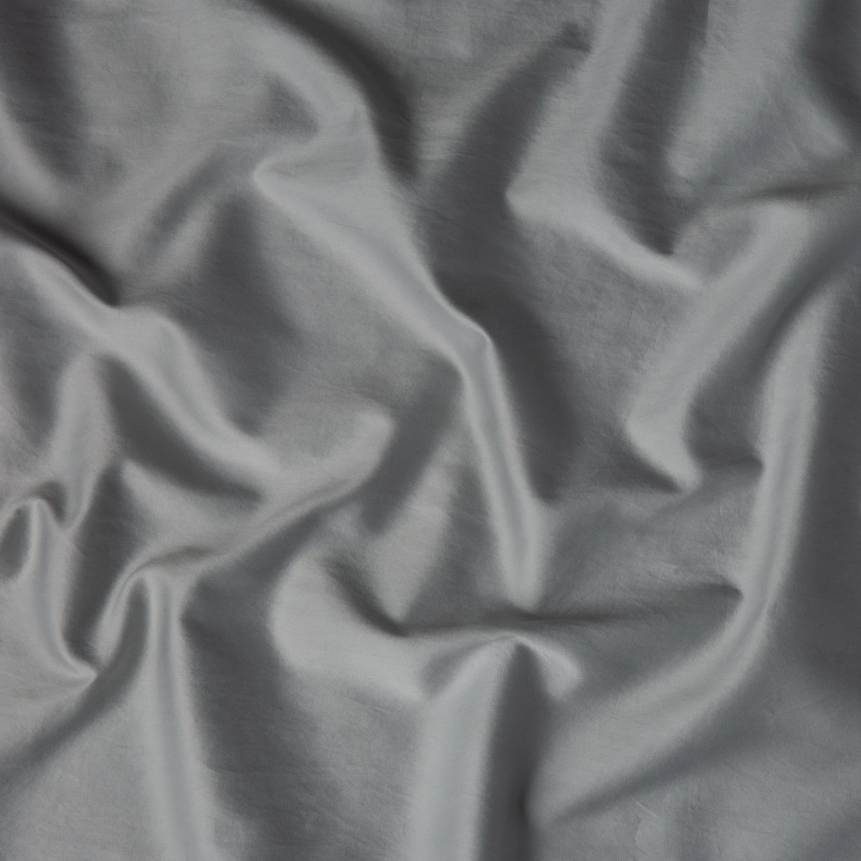 Mineral: A close up of cotton sateen fabric in mineral, a soothing seafoam blue with subtle grey-green undertones. 