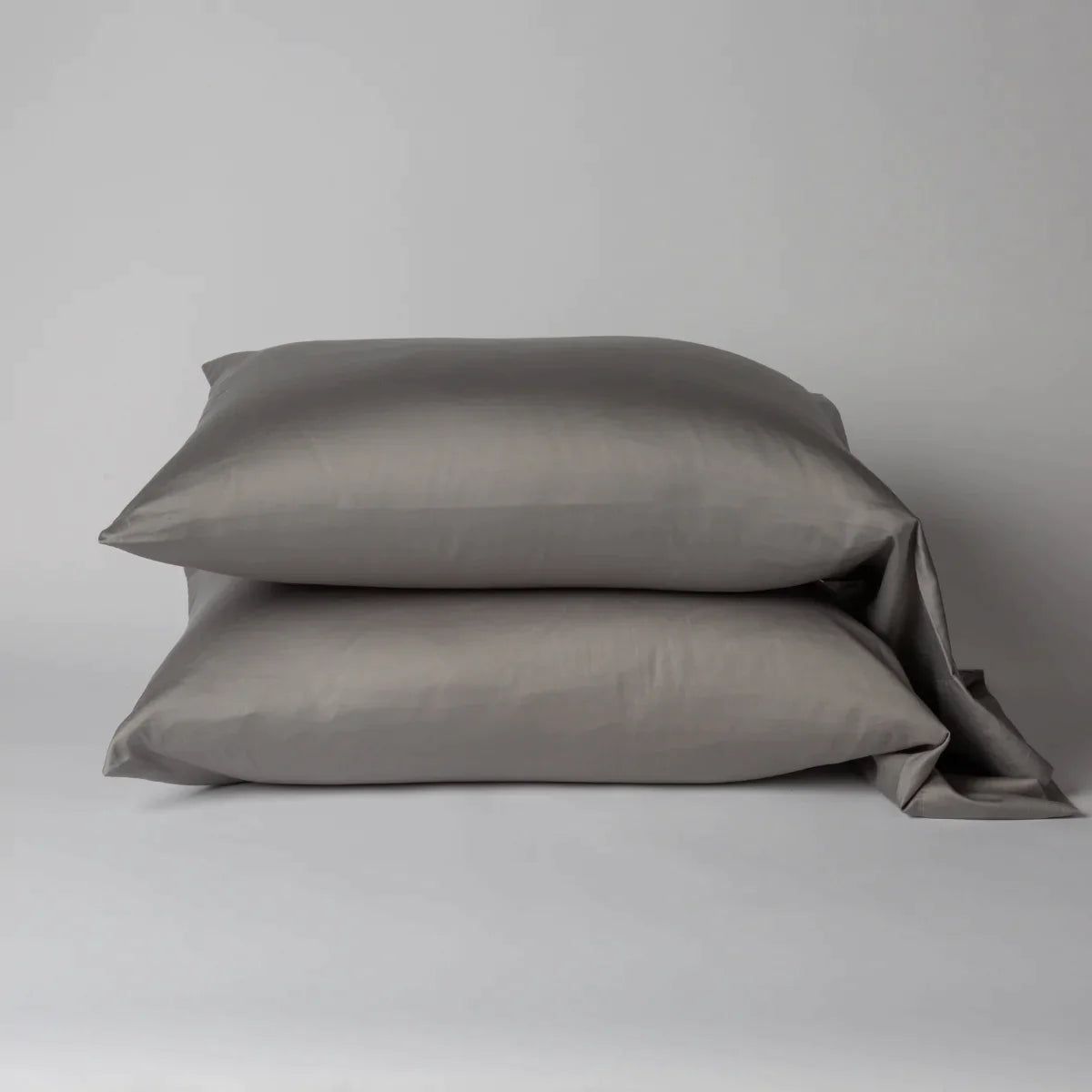 Moonlight: Two cotton sateen sleeping pillows, stacked neatly against a white backdrop - side view.
